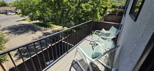 Private balcony featuring composite decking and black metal railings