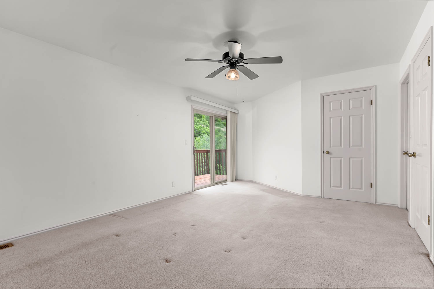Primary bedroom with balcony- unstaged