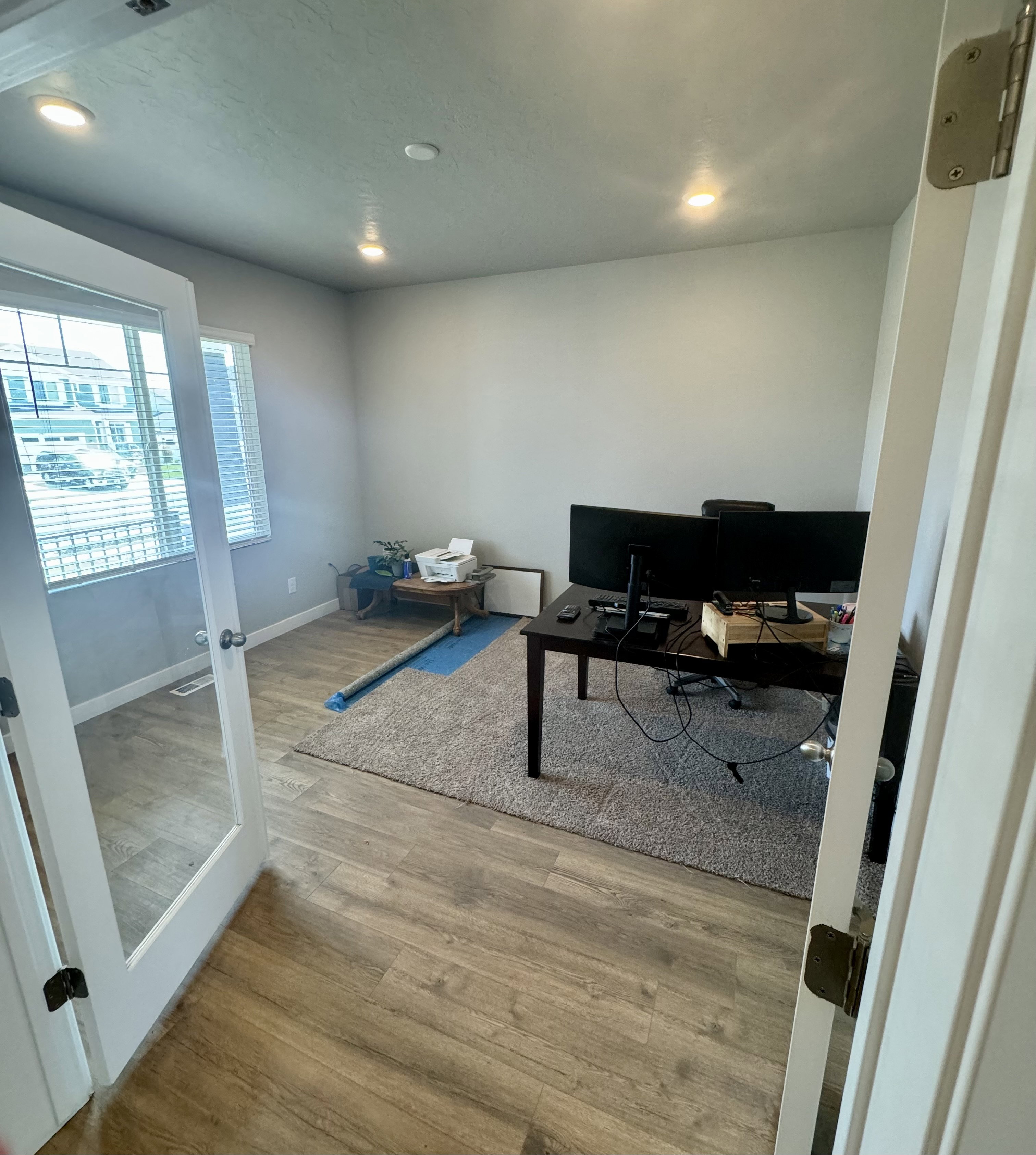 Room featuring wood-finish flooring, recessed lighting, and a window with blinds