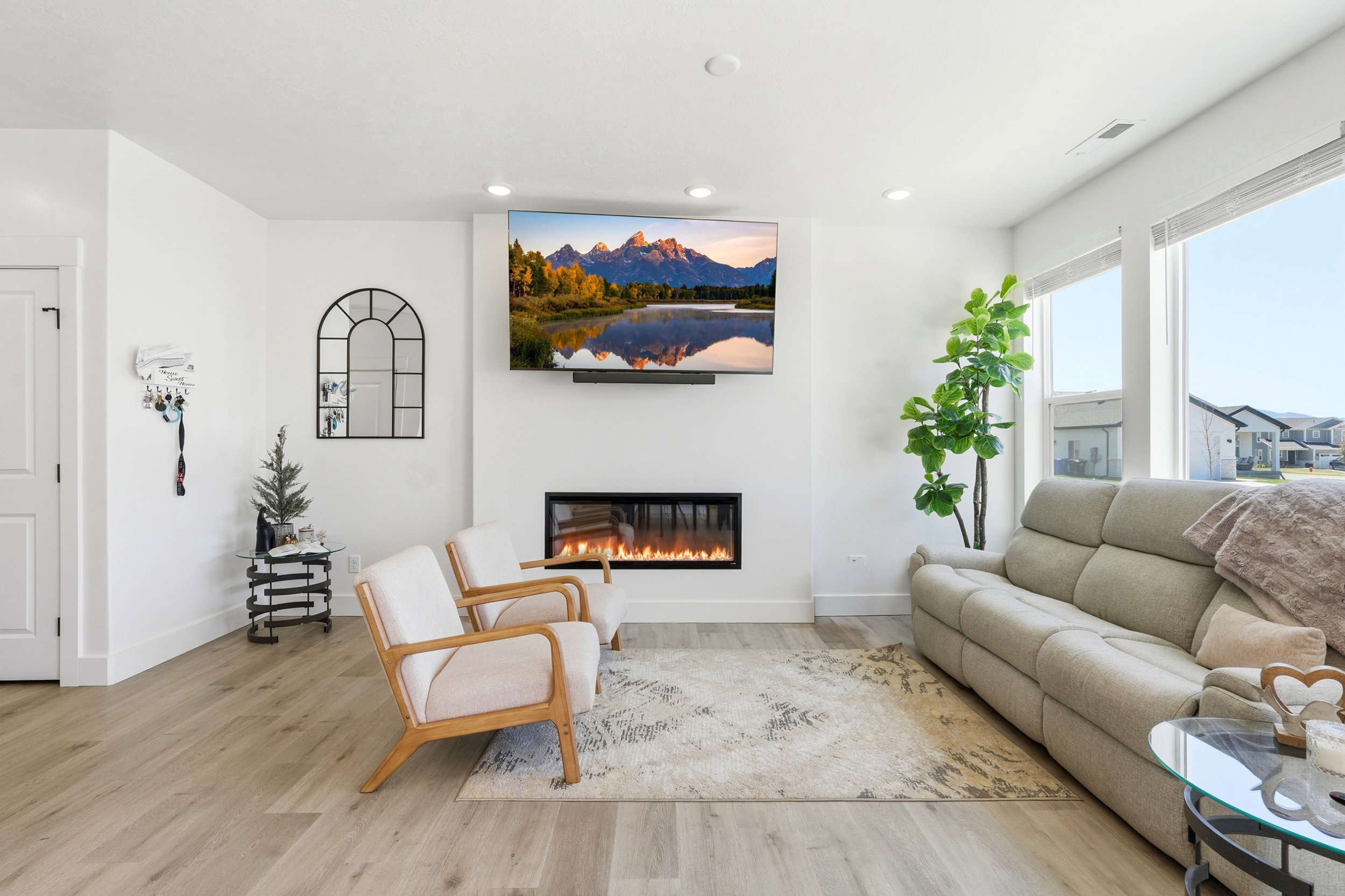 Living area featuring an integrated linear fireplace, recessed lighting, and wood-finish flooring