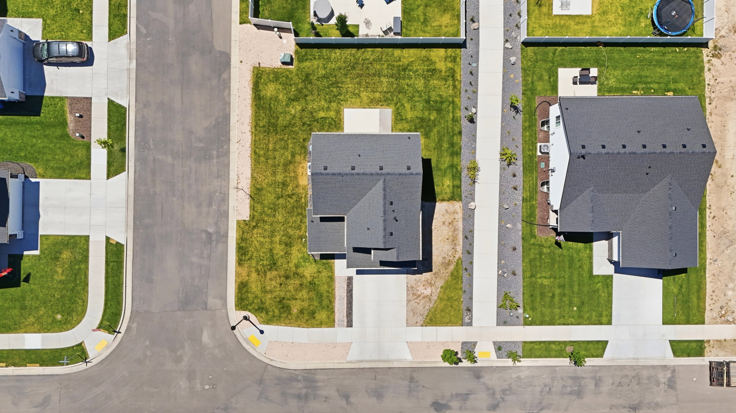 Contemporary residence with a dark shingle roof and light-colored siding