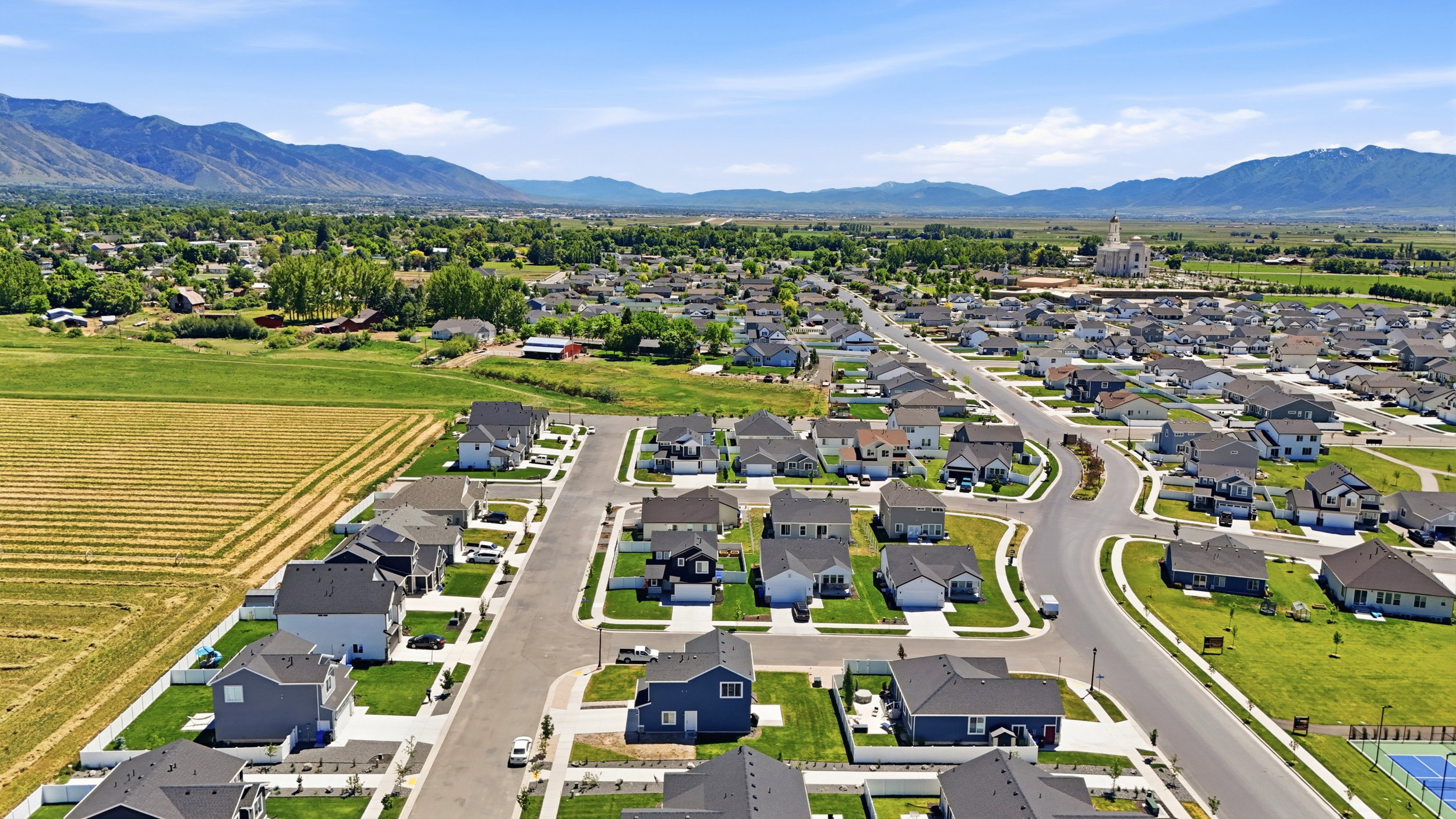 Expansive residential community with newly constructed properties, paved streets, and manicured landscaping
