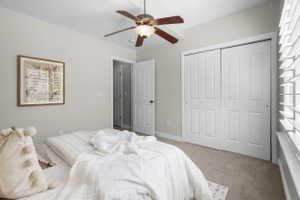 Recessed ceiling fan with light fixture, neutral wall paint, carpet flooring, dual-panel closet doors, and white plantation shutters