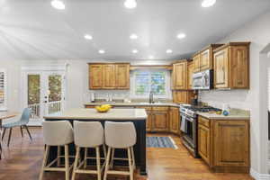 Kitchen with wood-finish flooring, recessed lighting, and natural wood cabinetry