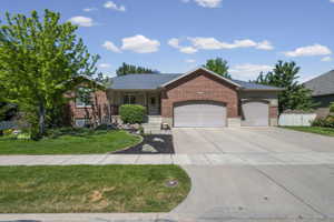 Brick exterior residence with a two-car garage and an additional single-car garage