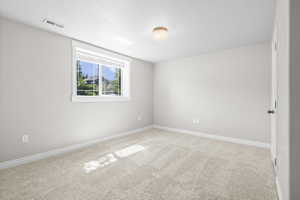 Neutral-toned walls complement plush carpeting