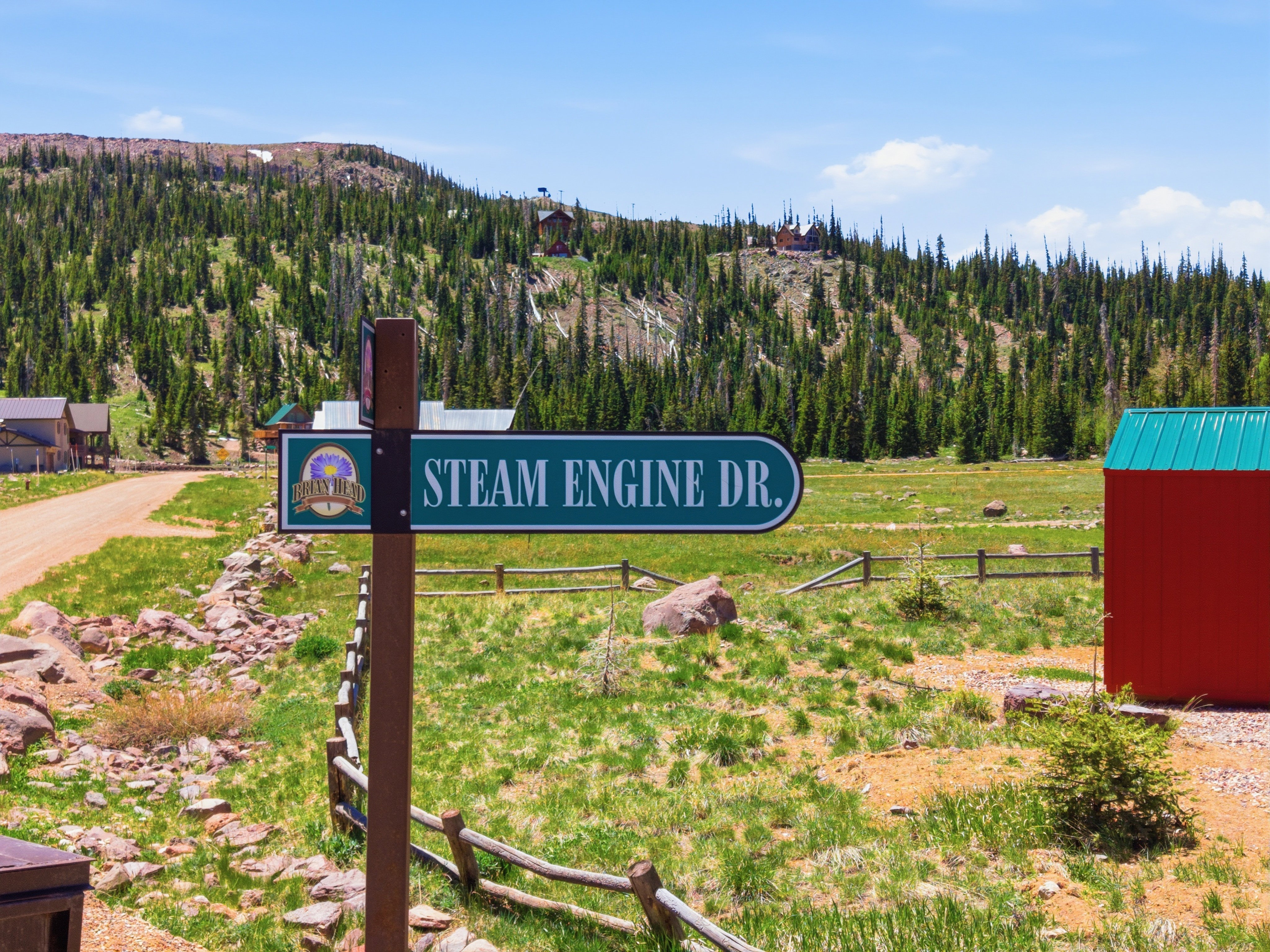 Directional street sign for "Steam Engine Dr." on a wooden post