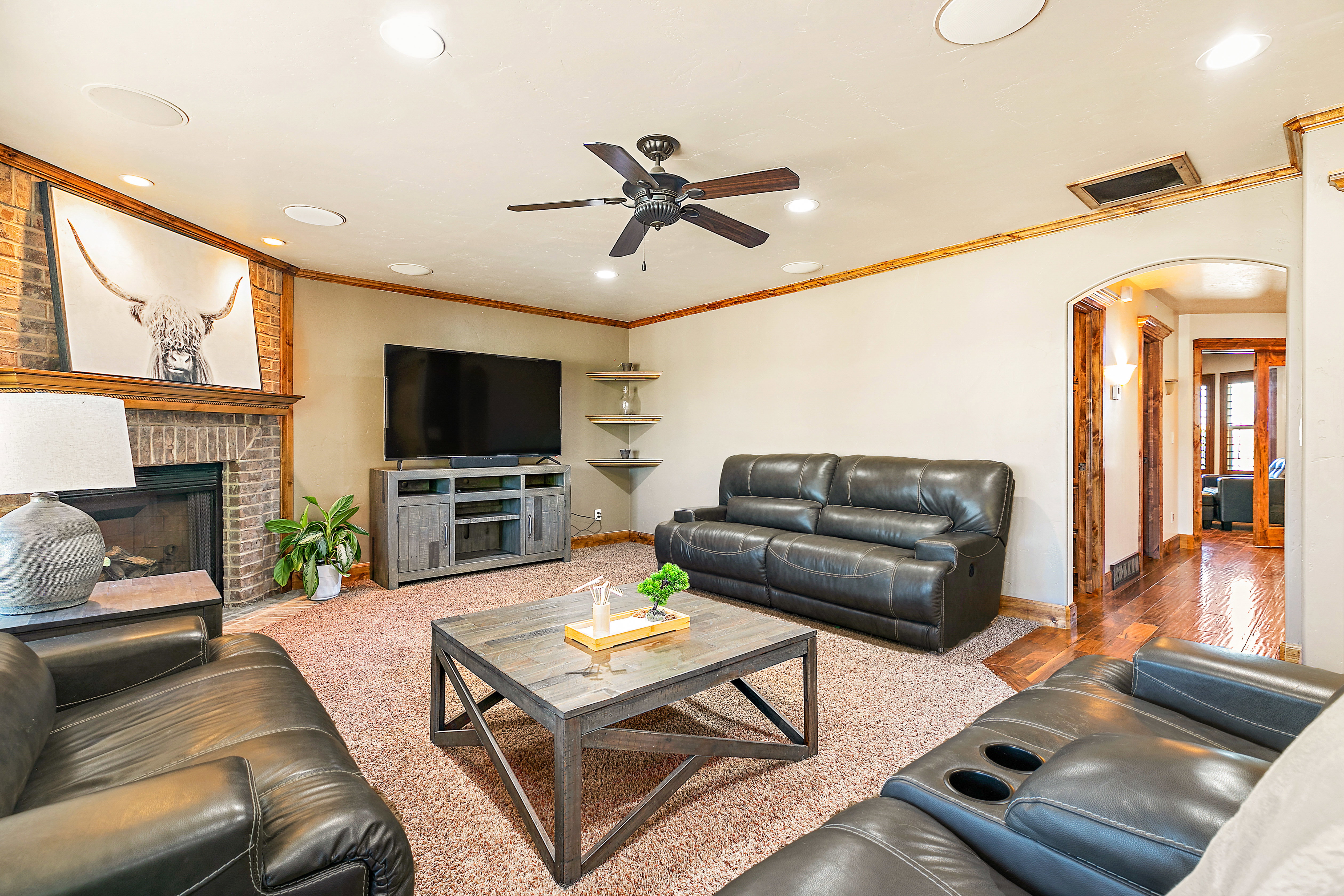 Living area featuring a brick fireplace, wood mantel, recessed lighting, and a ceiling fan