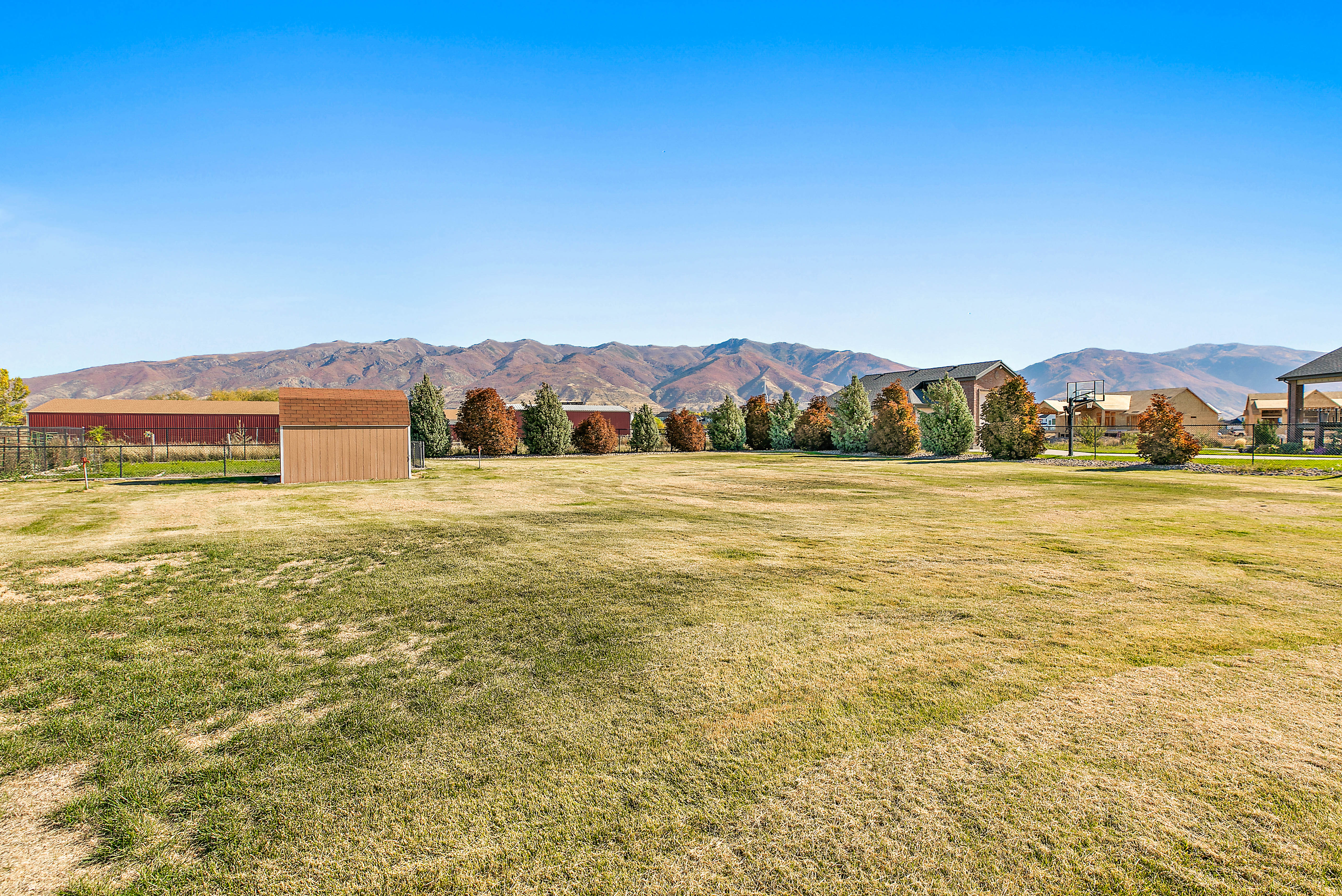 Expansive grassy yard with mountain scenery