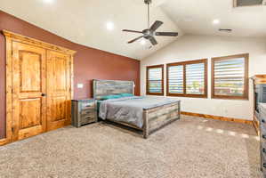 Vaulted ceilings with a ceiling fan, three windows with wood shutters, recessed lighting, and a neutral carpeted floor