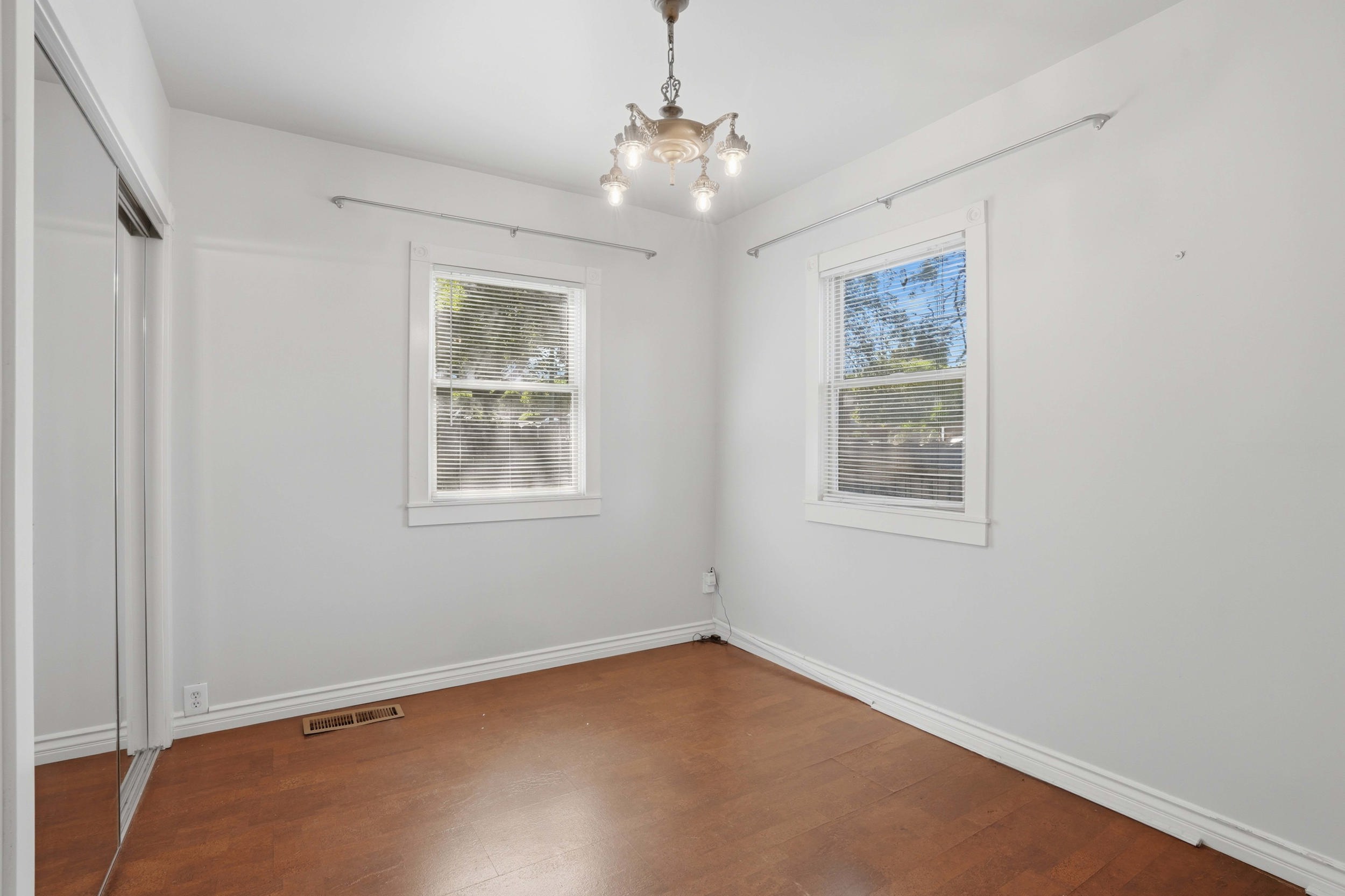 Interior room with wood-finish flooring and white baseboards