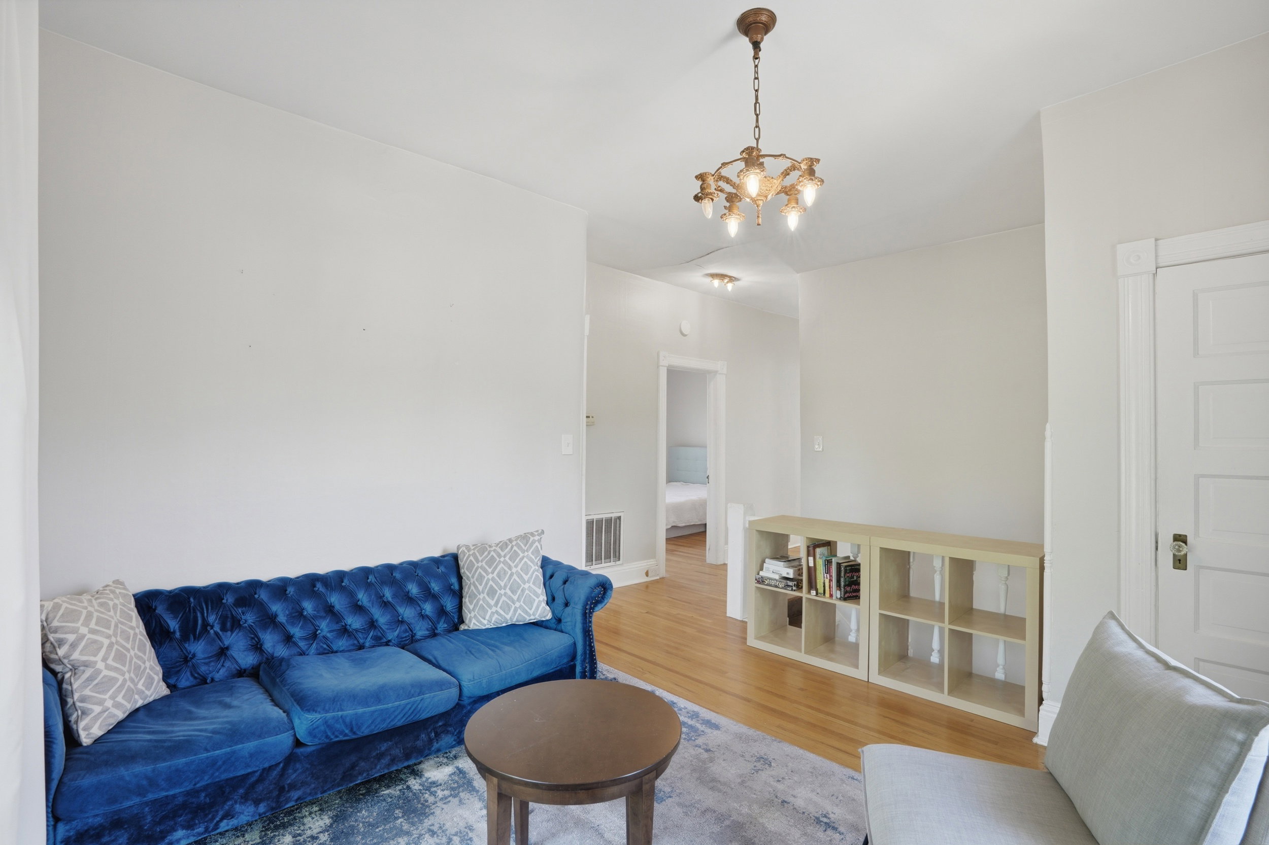 Light-toned wood-finish flooring complements the neutral wall color