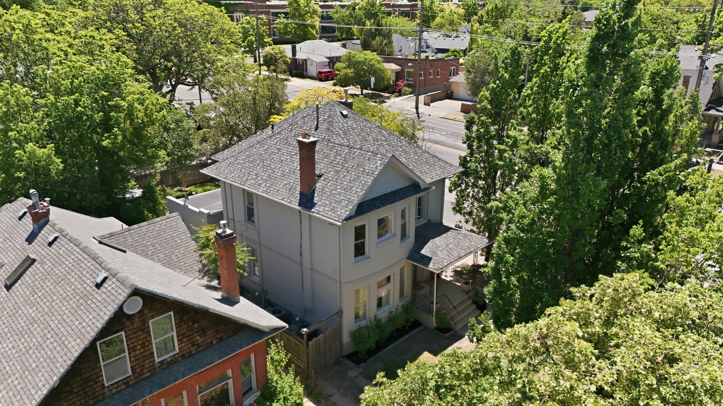 Two-story residence featuring a gabled roof and a prominent brick chimney