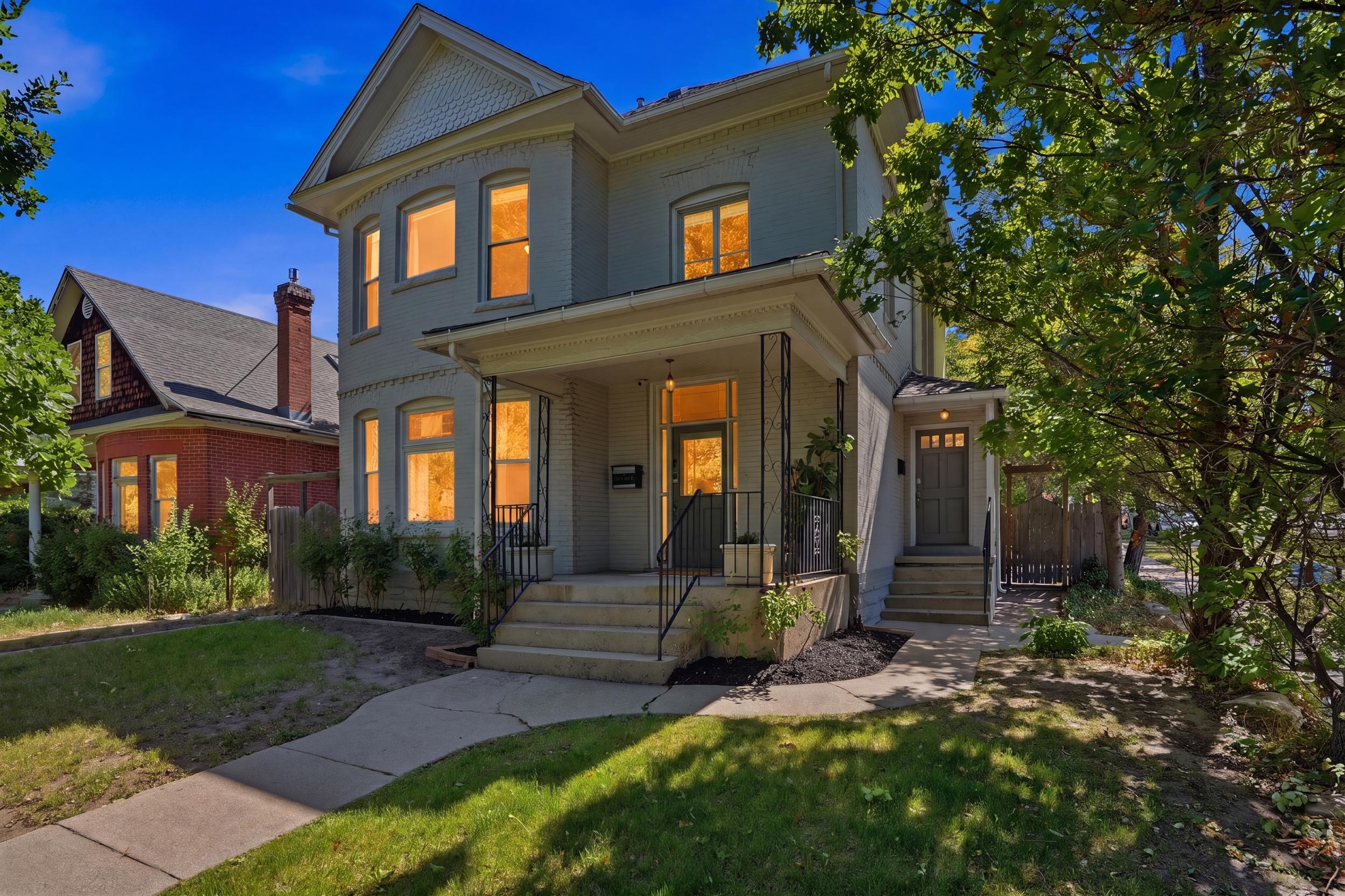Victorian-style residence featuring a prominent bay window, covered front porch, and a dedicated side entry