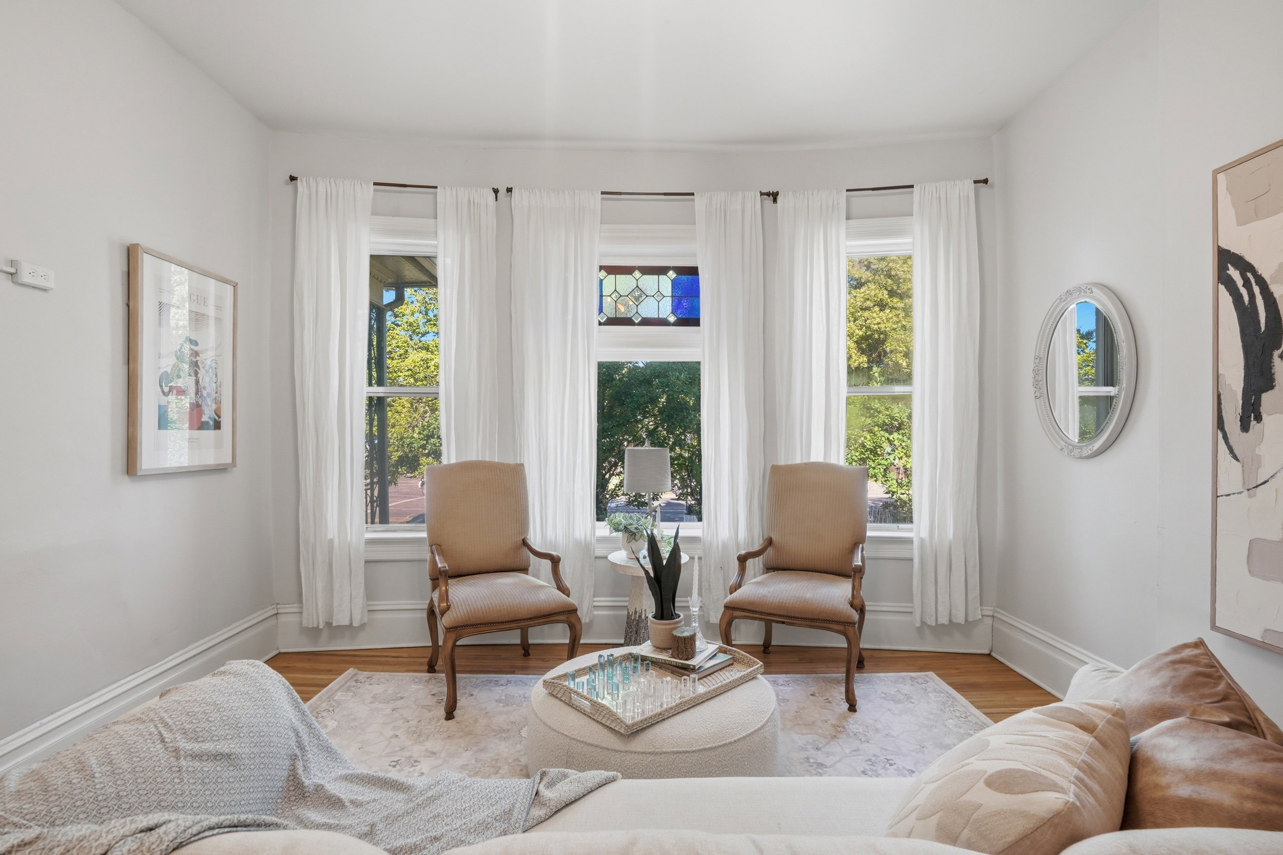 Bay window with three vertical windows, including a central stained glass accent