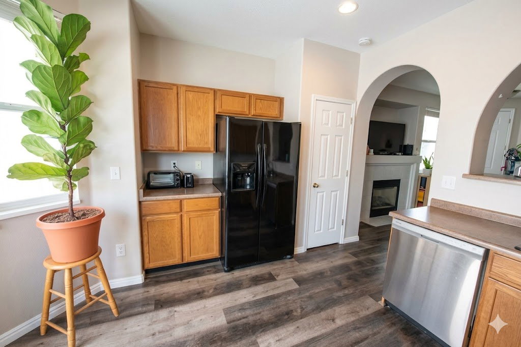 Kitchen featuring LVP flooring, light countertops, and wood finish cabinetry