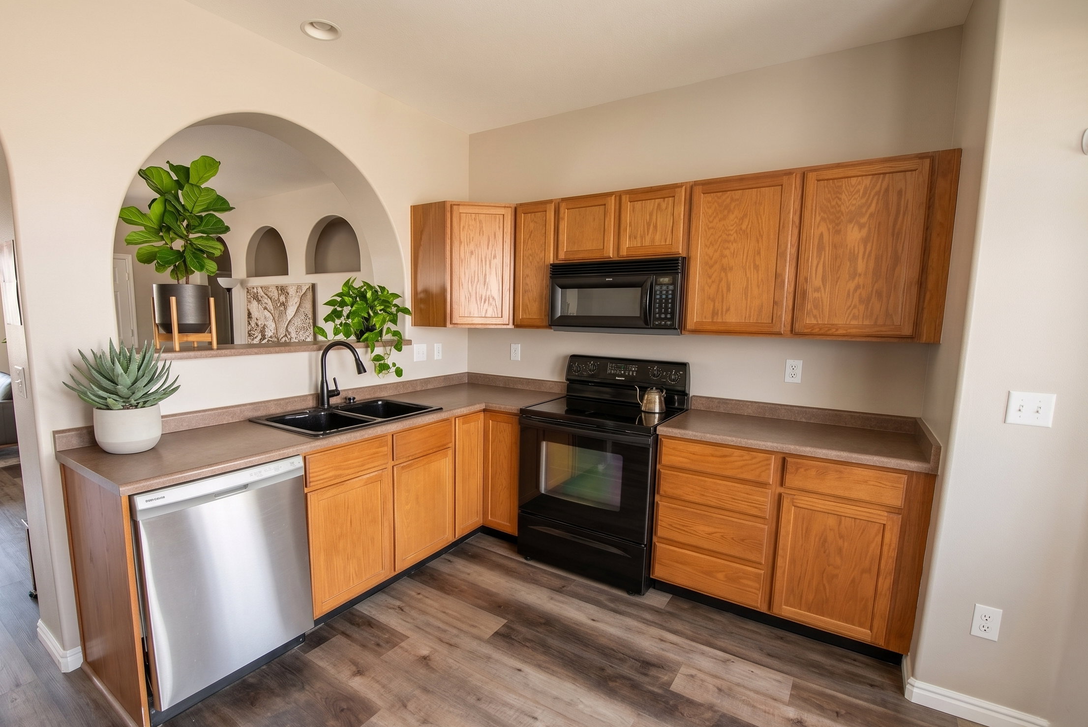 Kitchen featuring LVP flooring, light countertops, and wood finish cabinetry