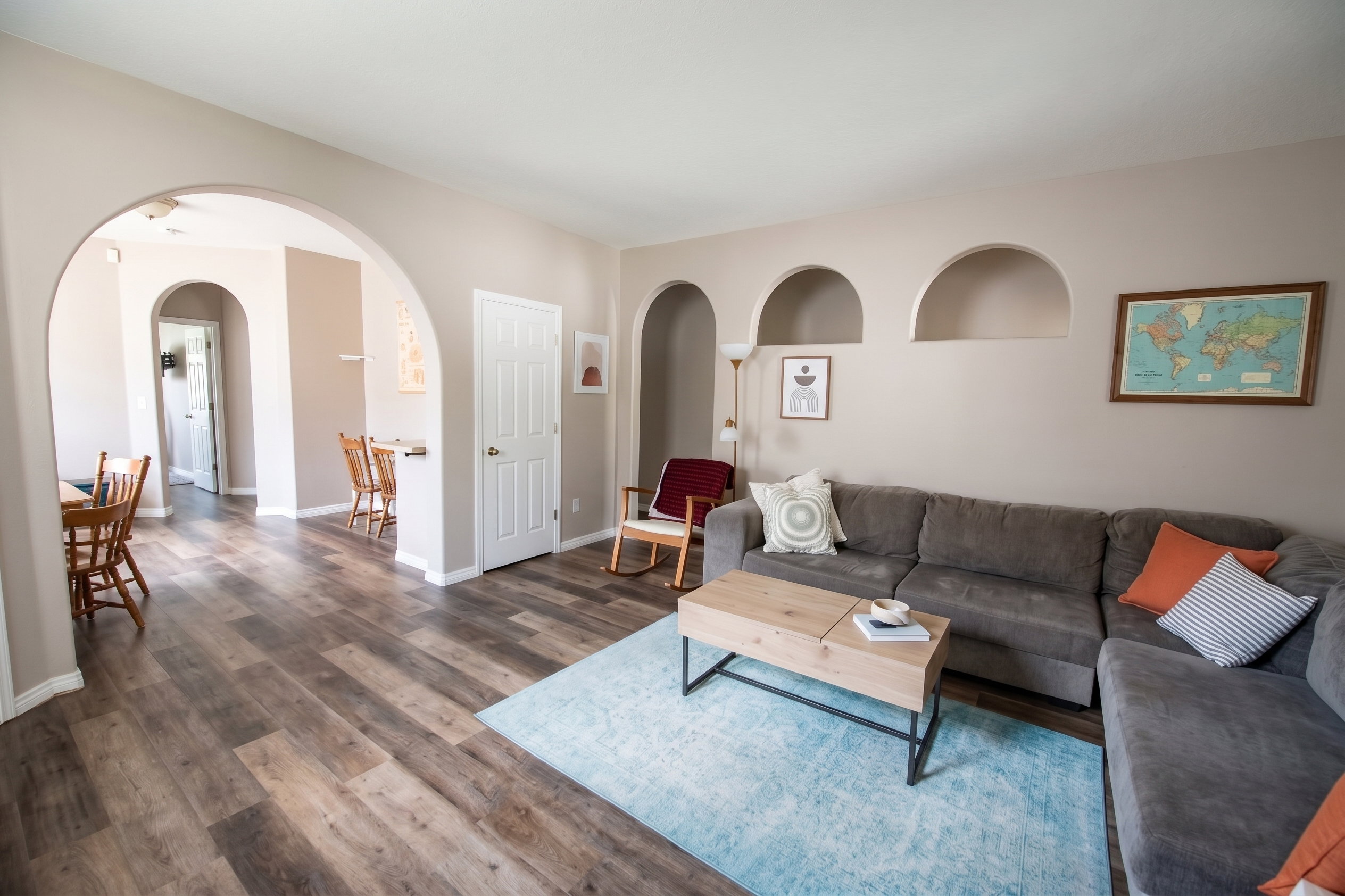 Living area with LVP floors and arched walkways