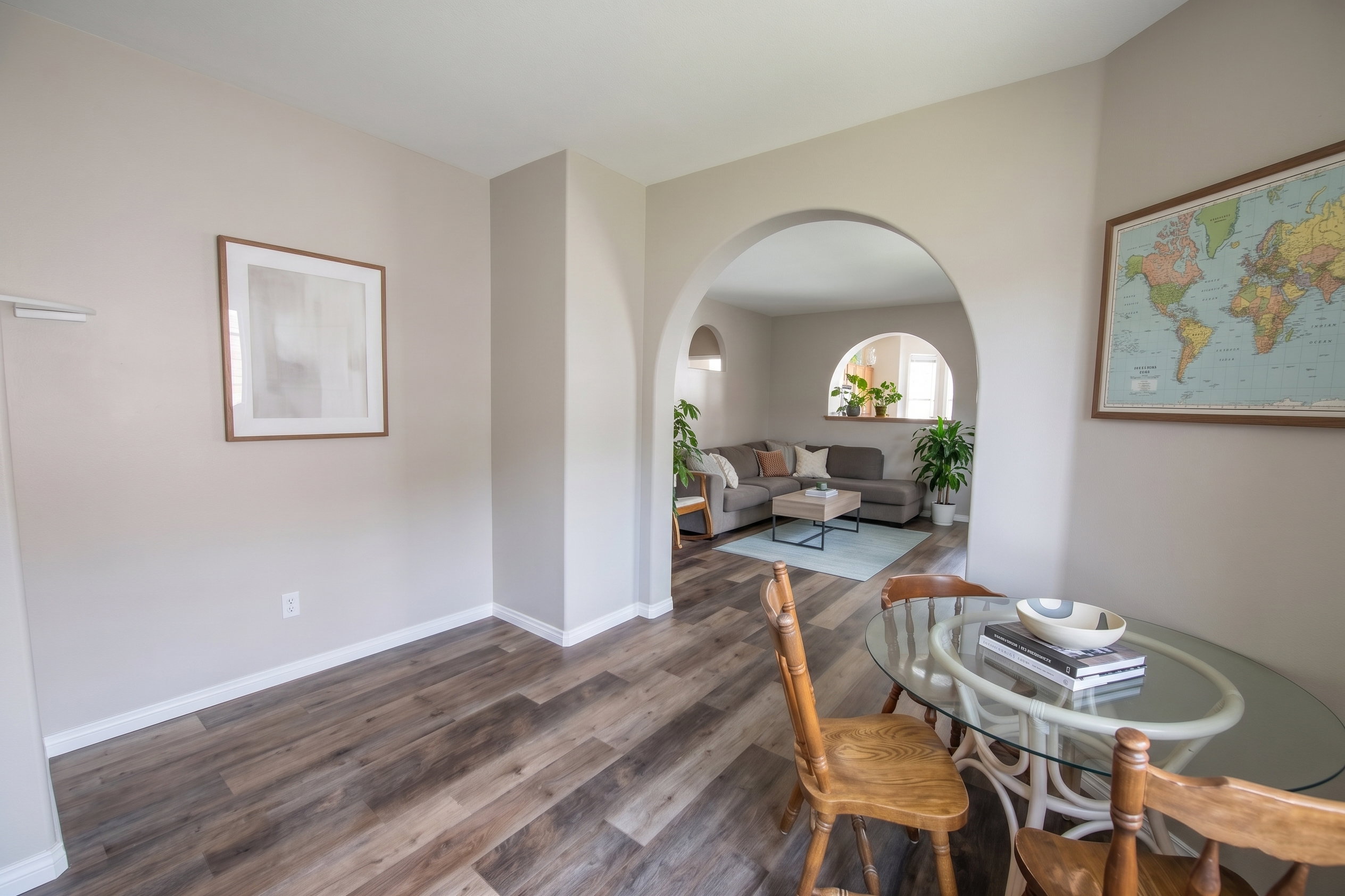 Dining space featuring LVP flooring and arched walkways