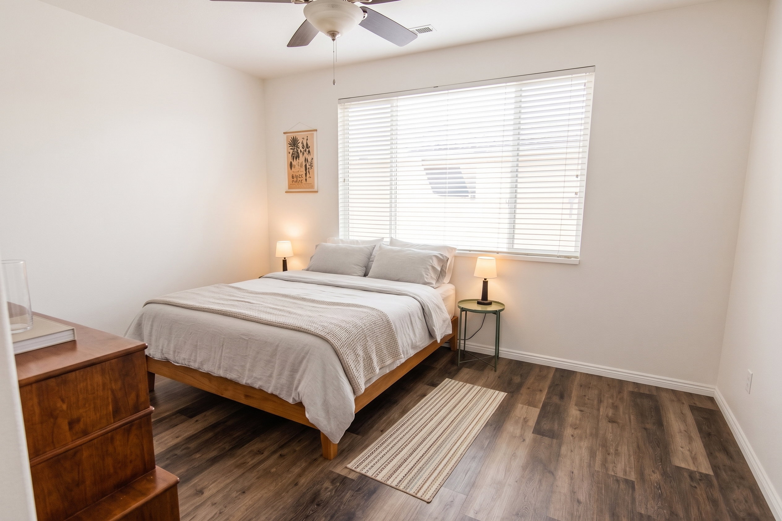 Bedroom featuring LVP flooring, a ceiling fan, and ensuite bathroom