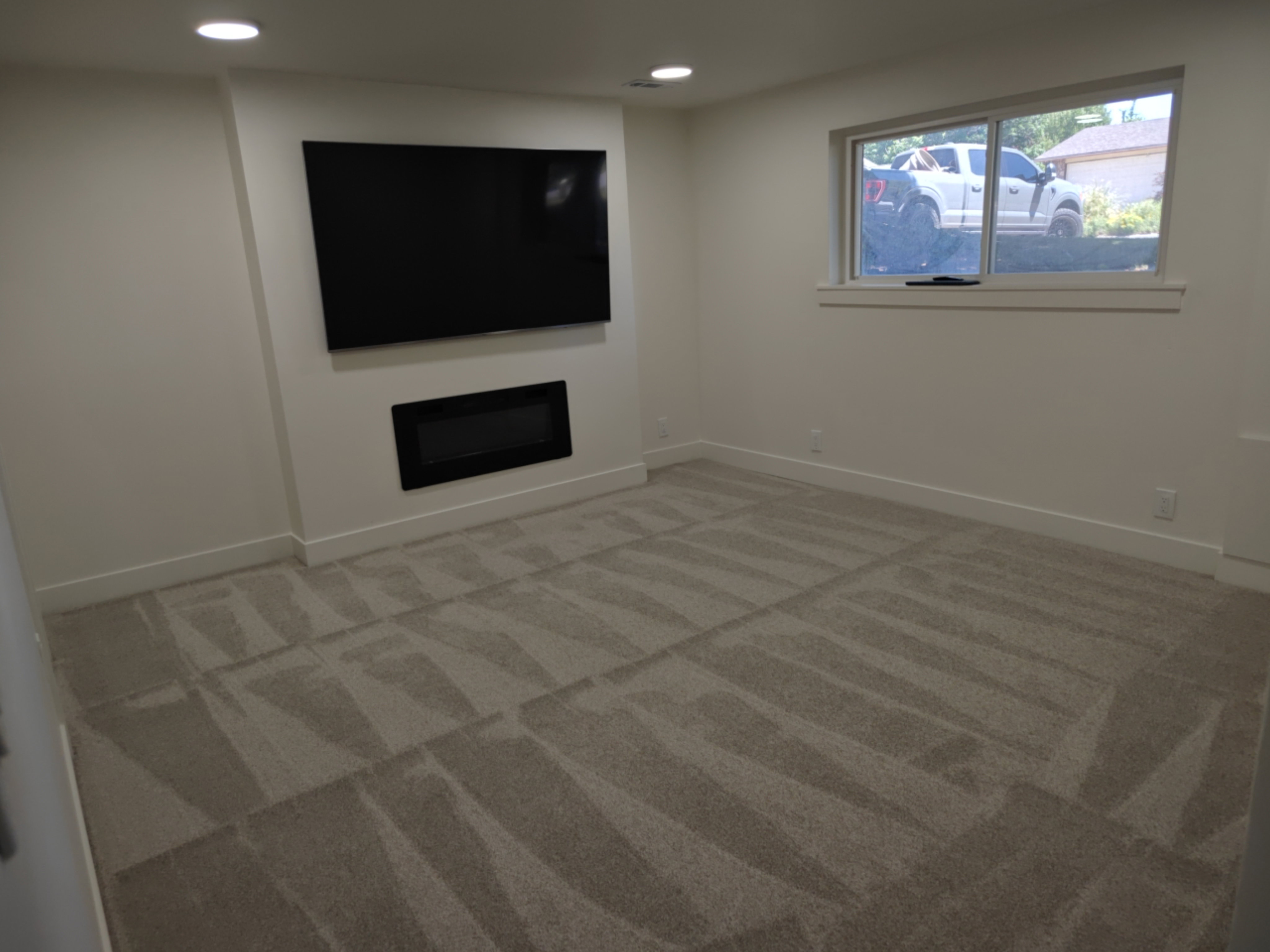 Recessed wall-mounted television and linear electric fireplace