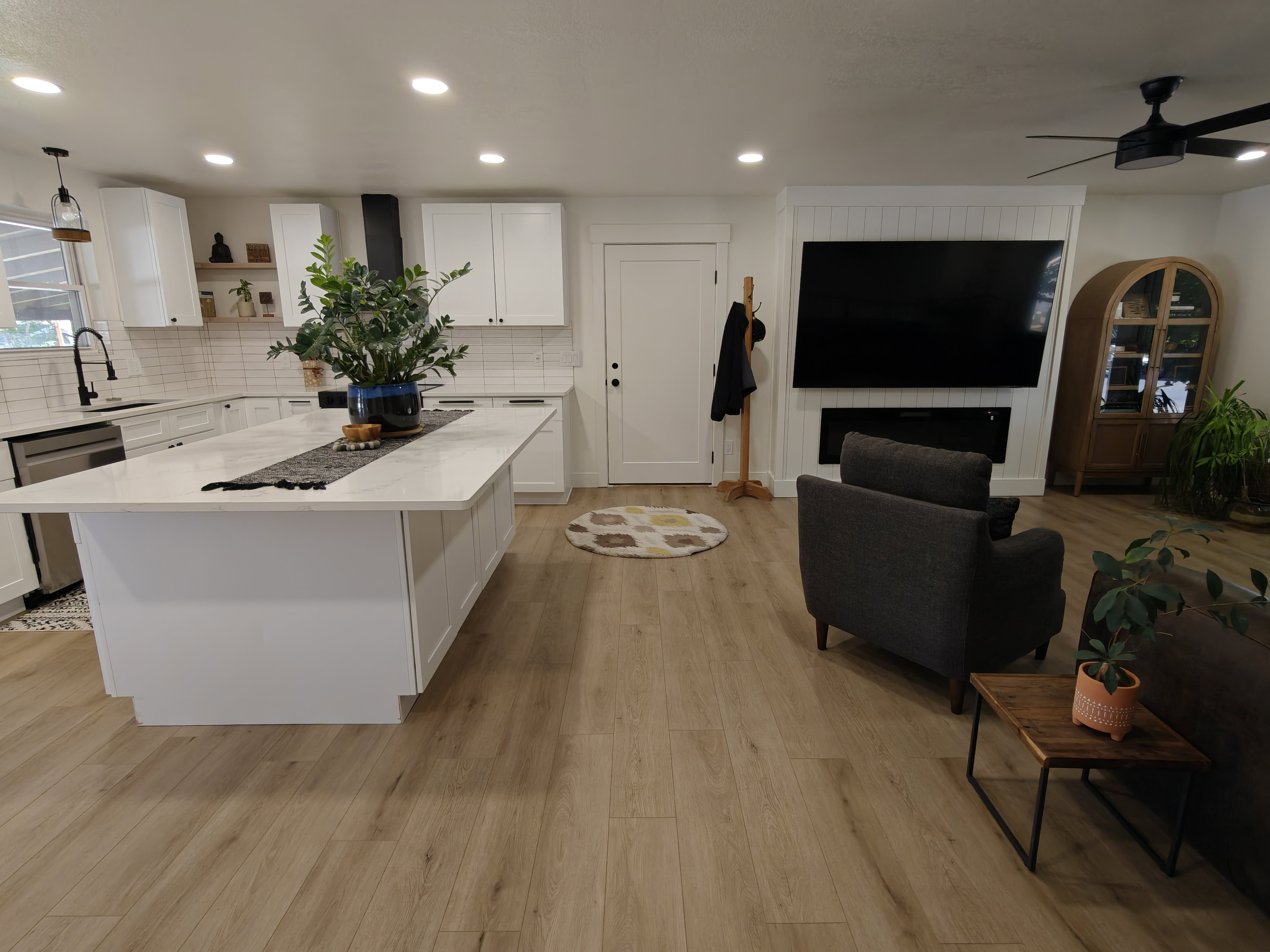 Open-concept living area featuring wood-finish flooring, recessed lighting, and a ceiling fan
