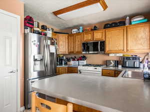 Kitchen featuring light wood cabinetry and light-toned countertops