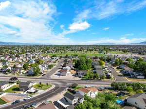 Aerial perspective showcasing a residential neighborhood with a large central green space