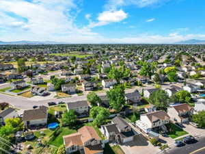 Residential neighborhood featuring a variety of single-family homes, mature trees, and paved streets