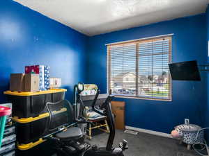 Room featuring a window with horizontal blinds, providing natural light and exterior views