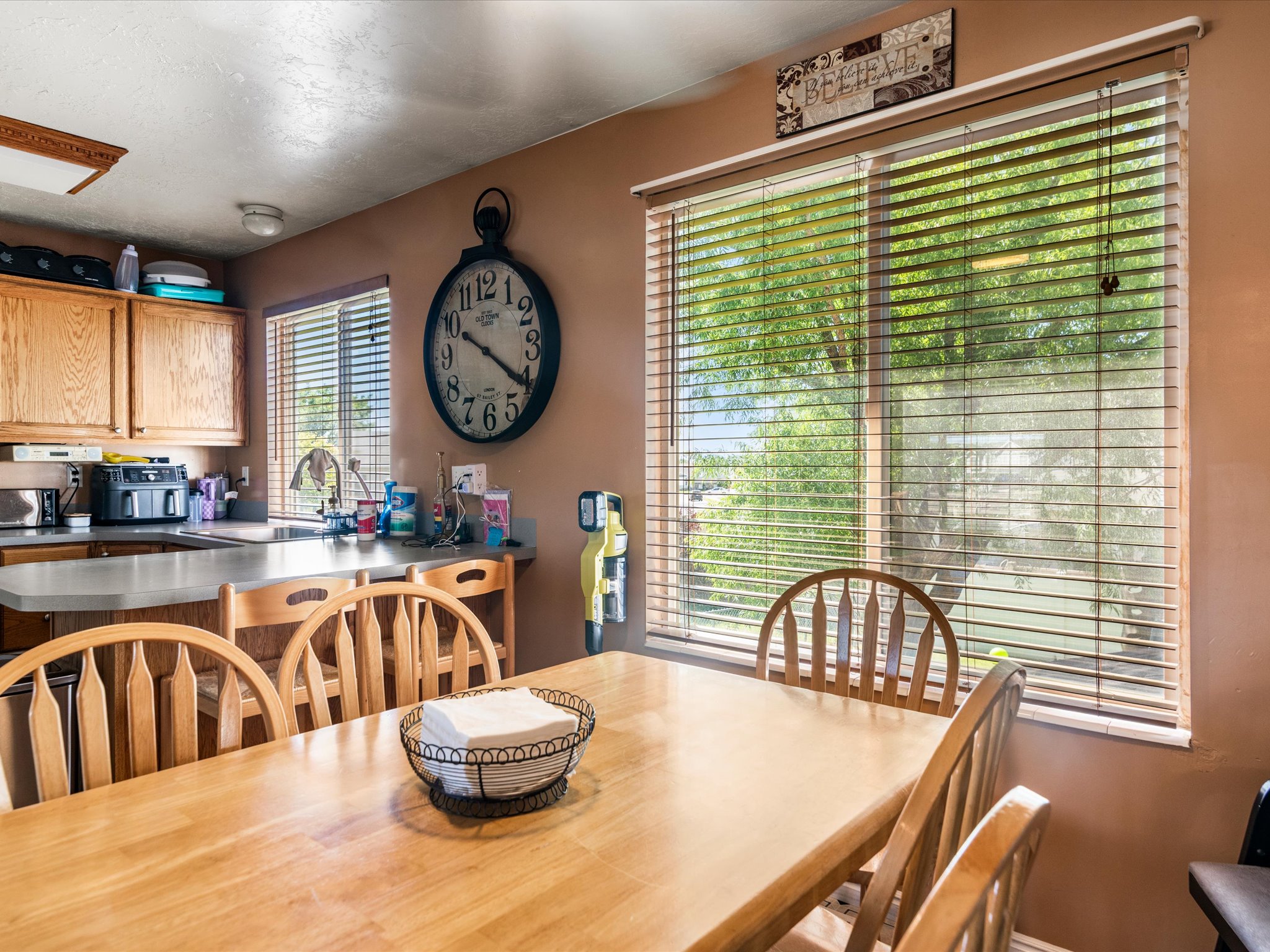 Bright kitchen with wood-finish cabinetry and a large window