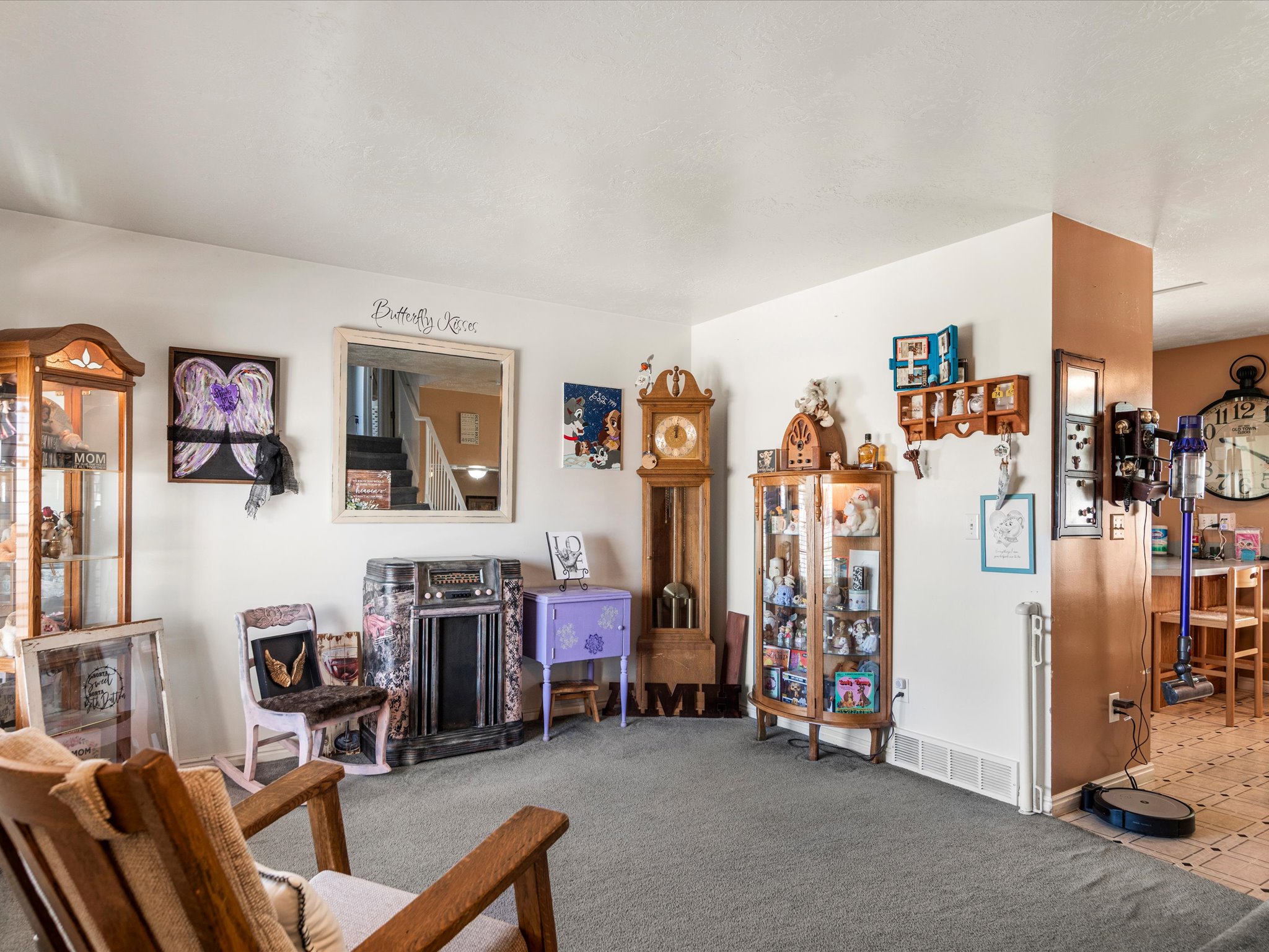 Carpeted living area featuring white walls and a mirrored accent