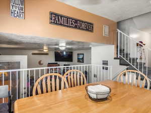 Open floor plan featuring a carpeted staircase and white railings