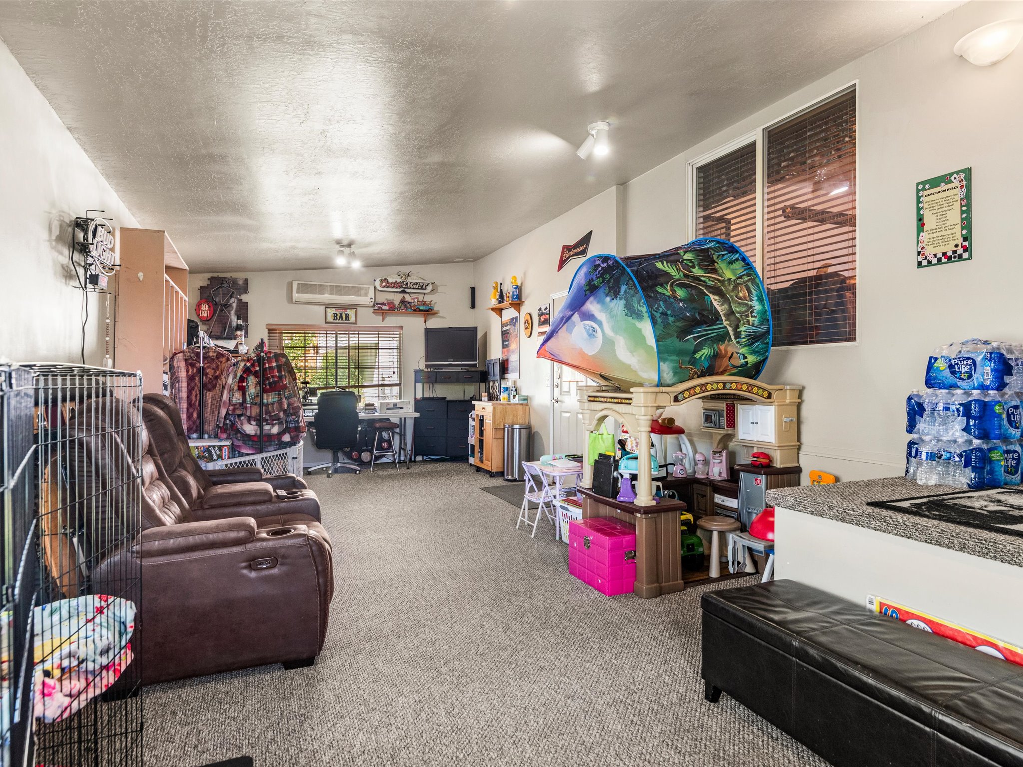 Spacious room featuring carpeting, recessed lighting, and multiple windows with blinds