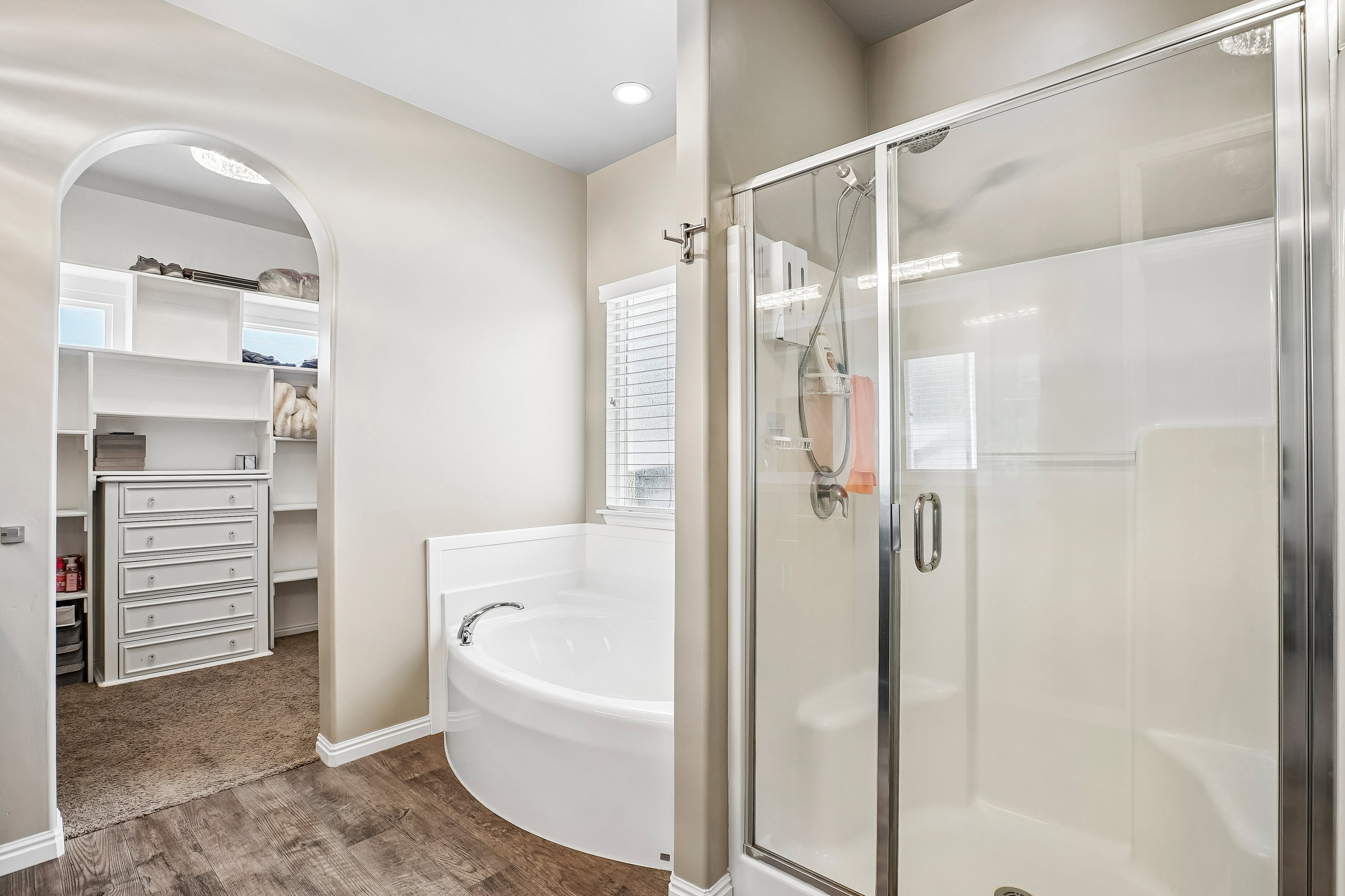 Bathroom with a built-in circular soaking tub and a separate glass-enclosed shower