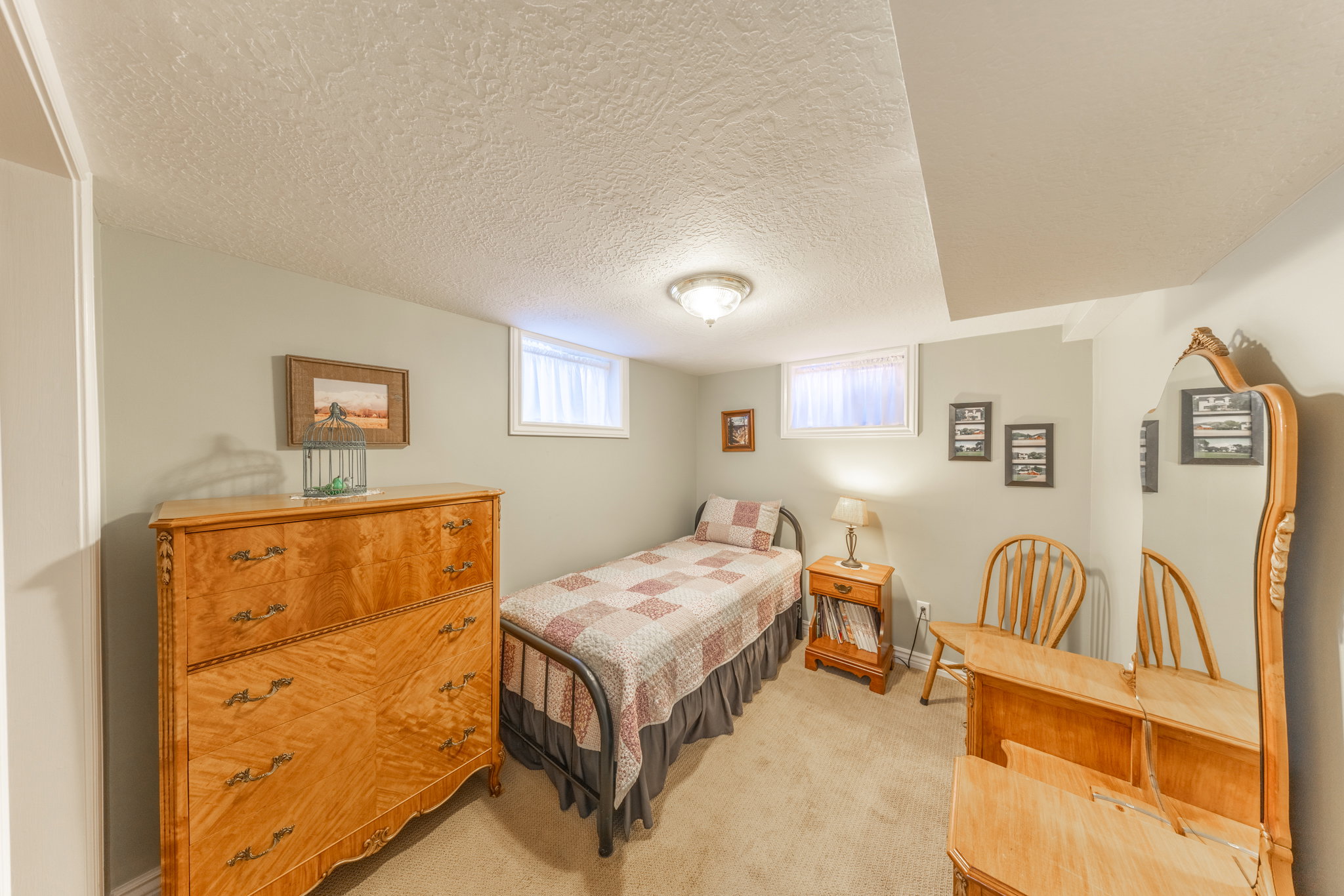 Carpeted room with light-toned walls and a textured ceiling