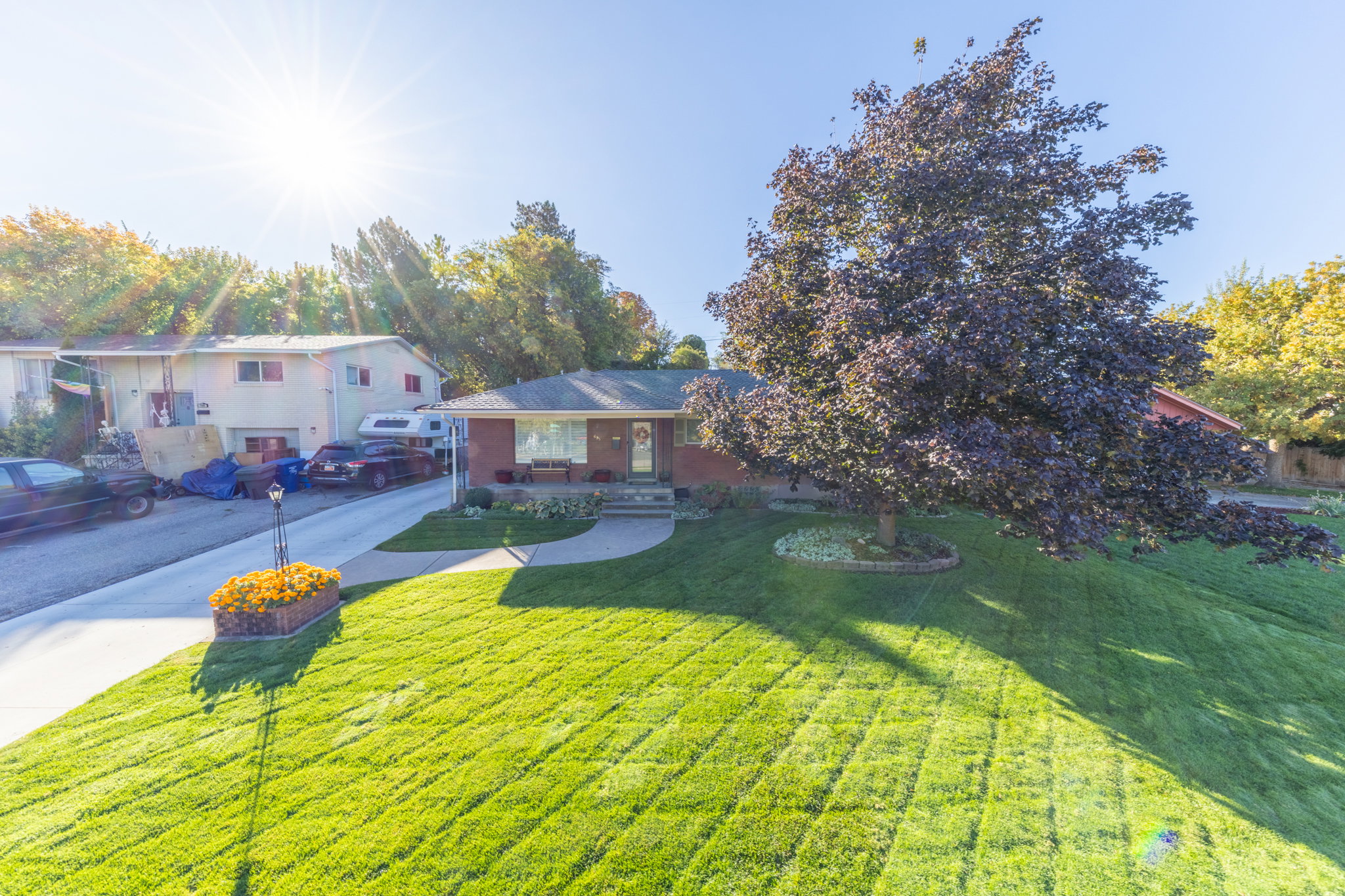 Brick exterior residence with a sloped, manicured lawn