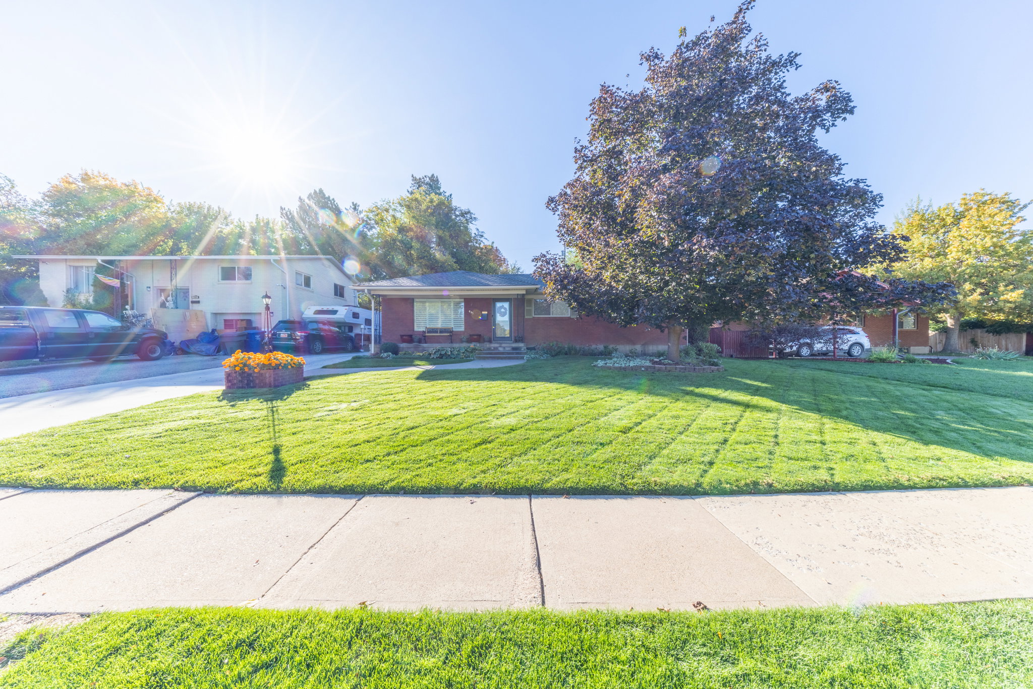 Front exterior featuring brick construction and a manicured lawn