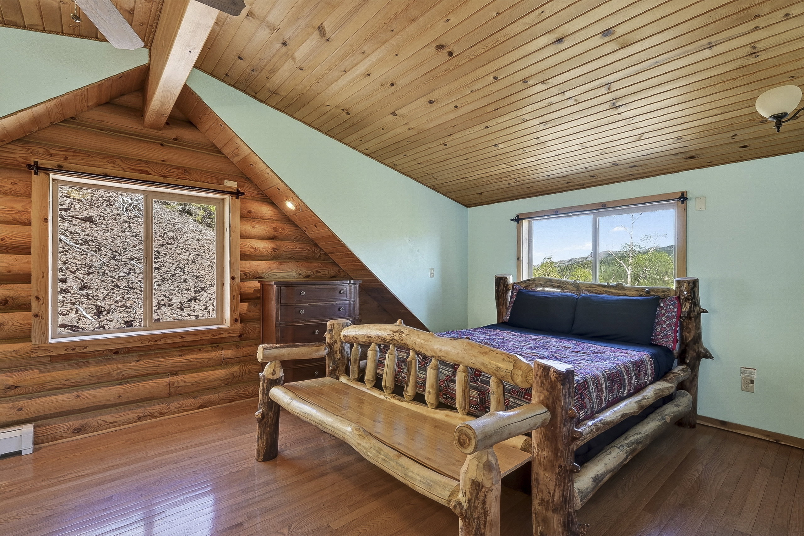 Log cabin interior featuring wood-finish flooring and a wood plank ceiling