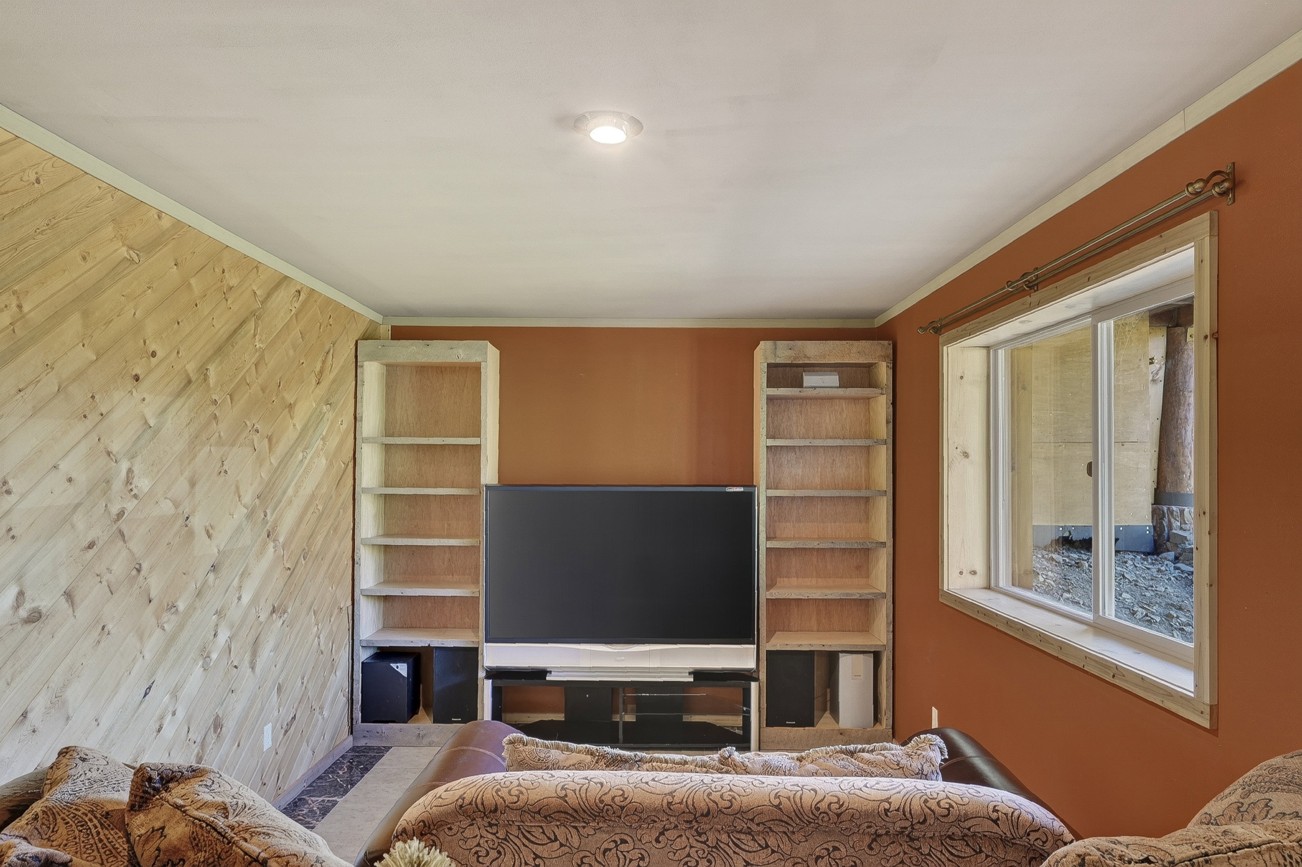 Living area featuring a wall with diagonal wood paneling and a contrasting painted accent wall