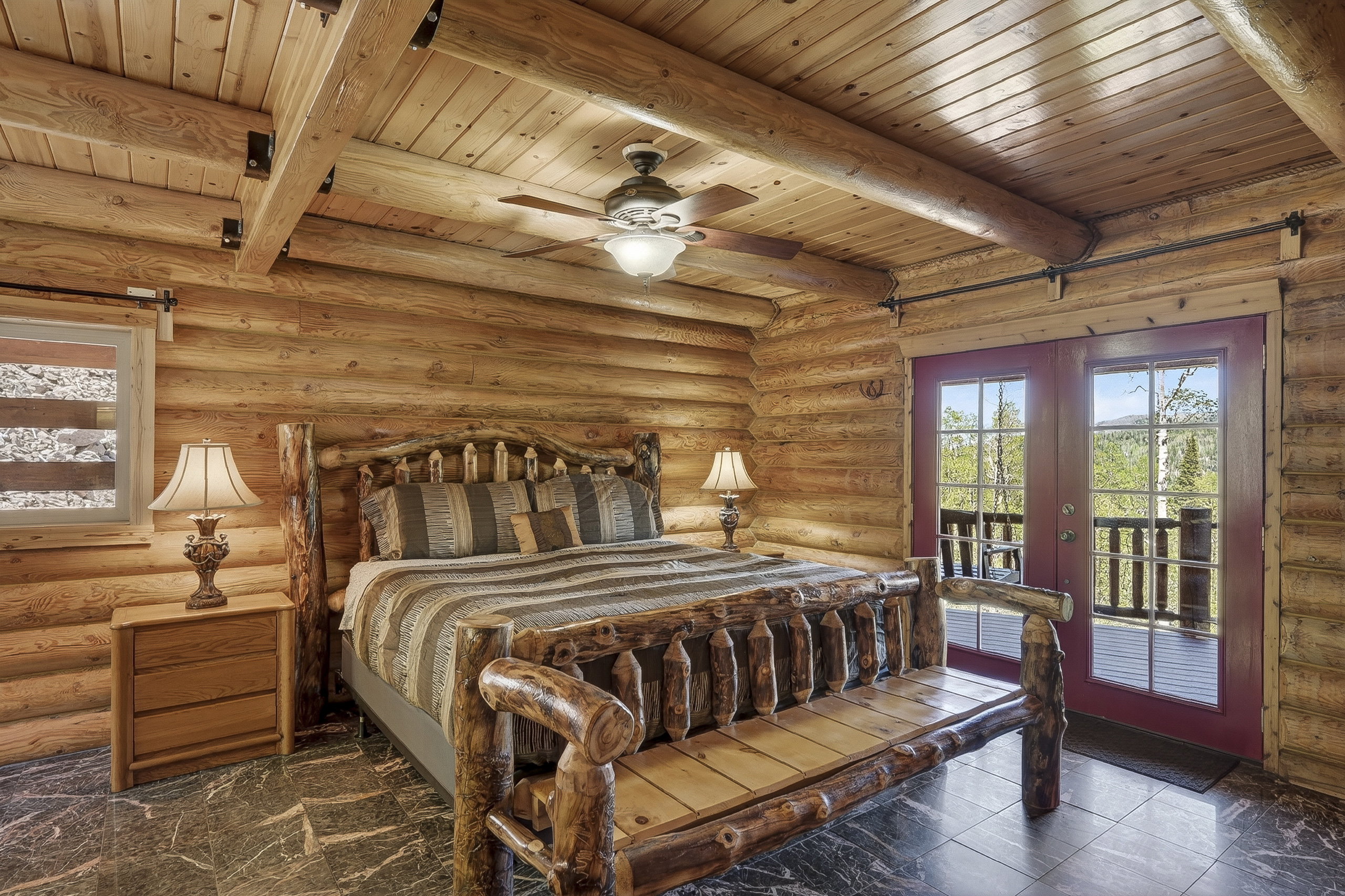 Solid log construction featuring exposed timber beams and wood-paneled ceilings