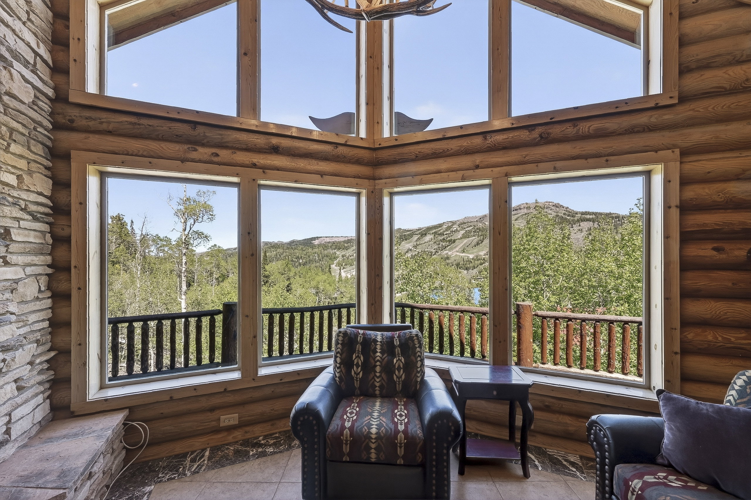 Expansive window wall with mountain and tree scenery