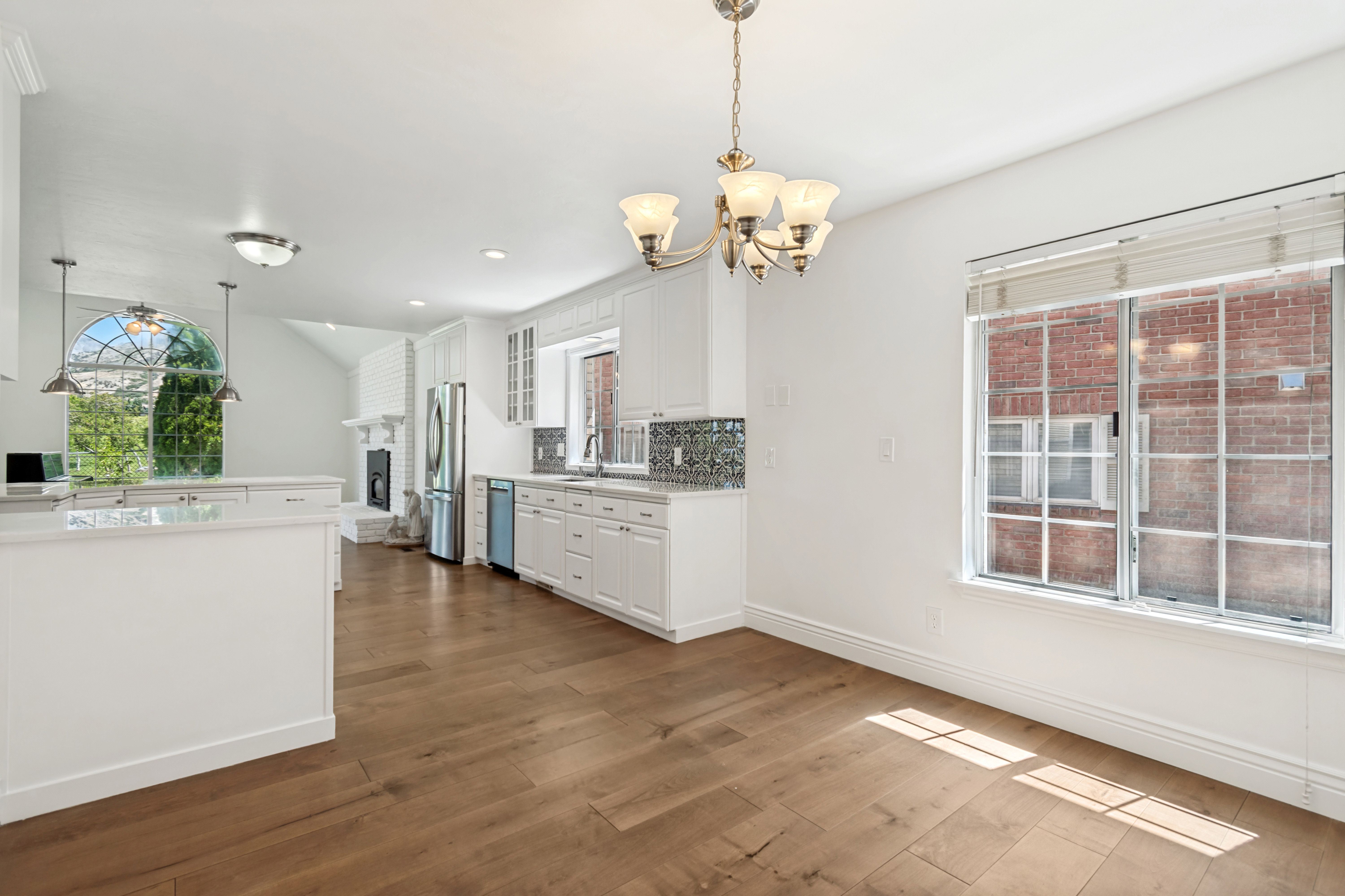 Open-concept kitchen and dining area featuring wide plank wood-finish flooring