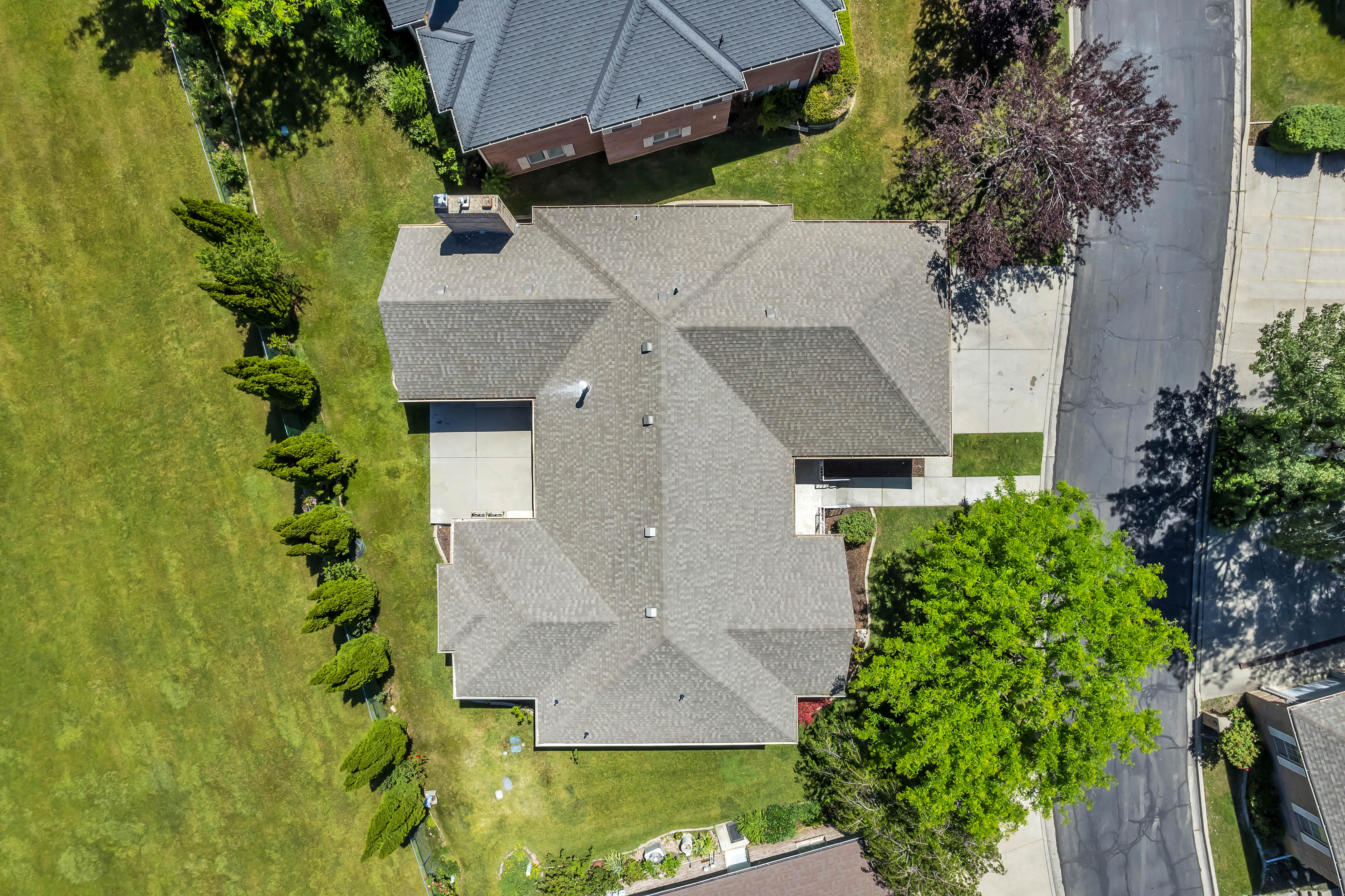 Aerial perspective showcasing a multi-gabled roofline with asphalt shingles