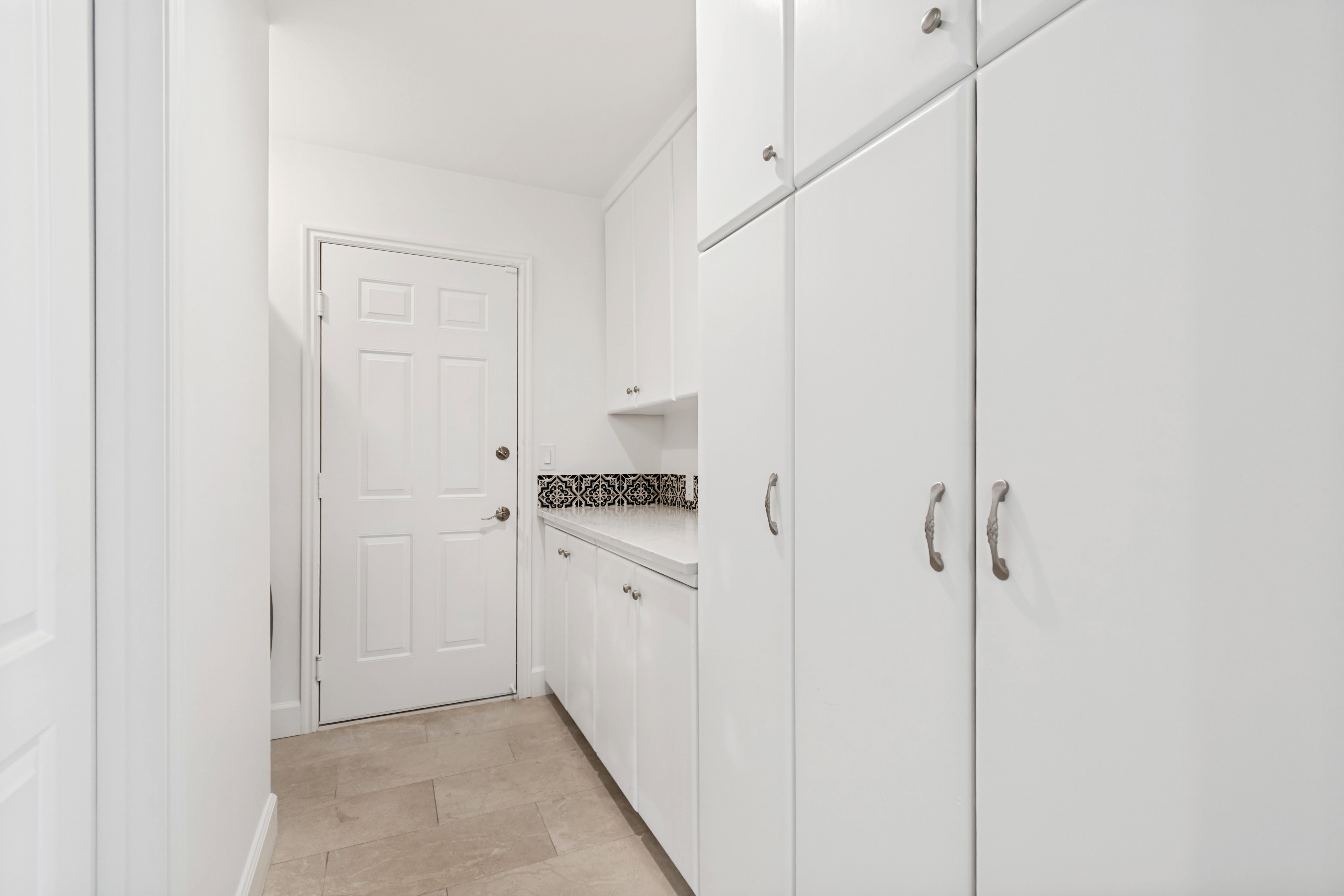 White paneled door with brushed nickel hardware