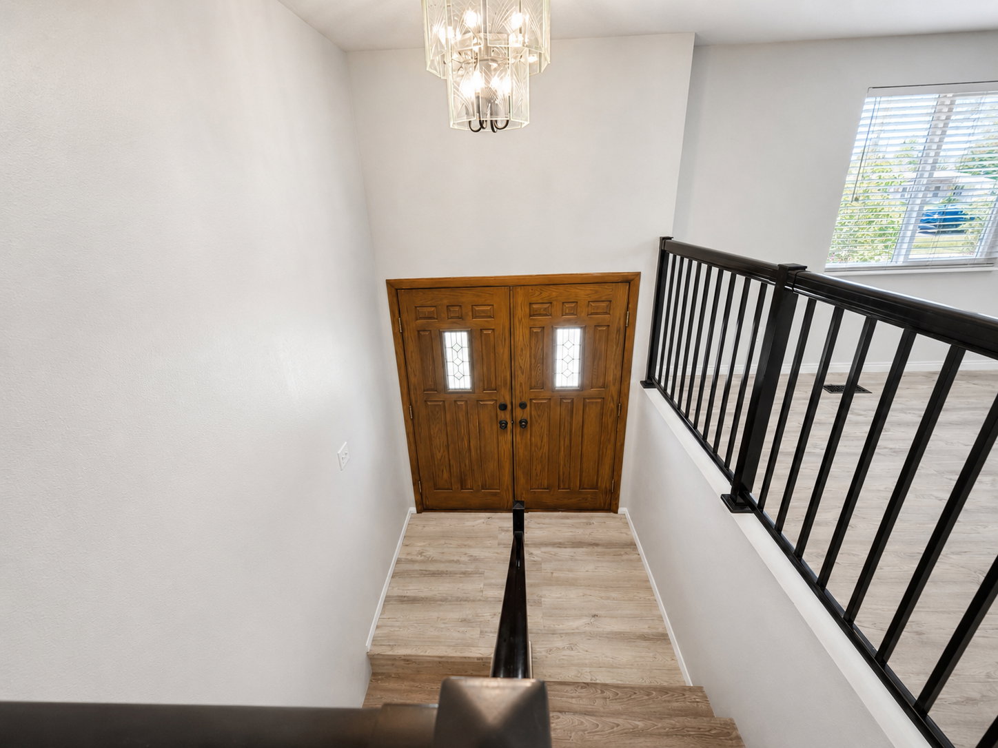 Dual wooden entry doors with decorative glass inserts