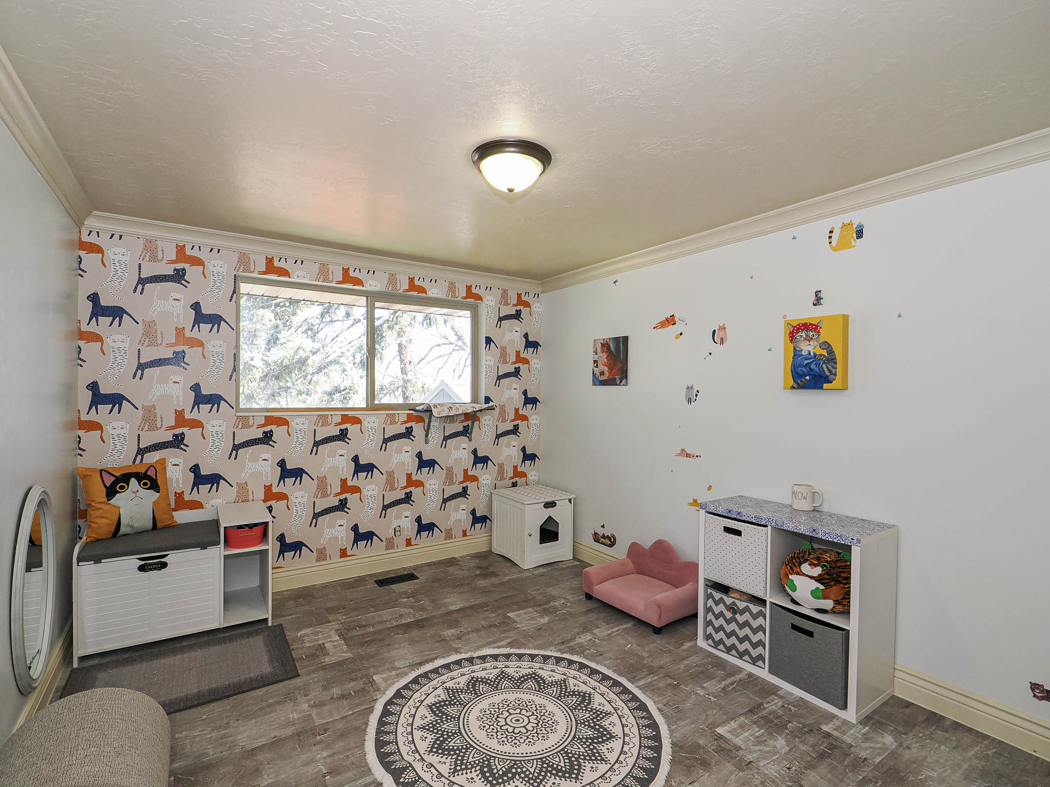 Bright room featuring wood-finish flooring and crown molding