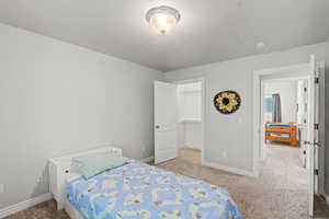 Carpeted room with light gray walls, white trim, and a semi-flush mount ceiling light
