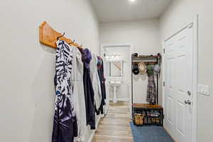 Entryway with wood-finish flooring, white paneled door, and neutral wall paint