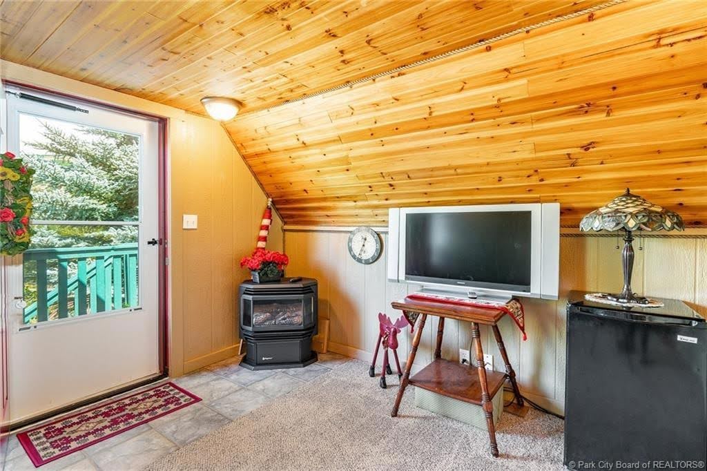 Vaulted wood-paneled ceiling with an integrated light fixture